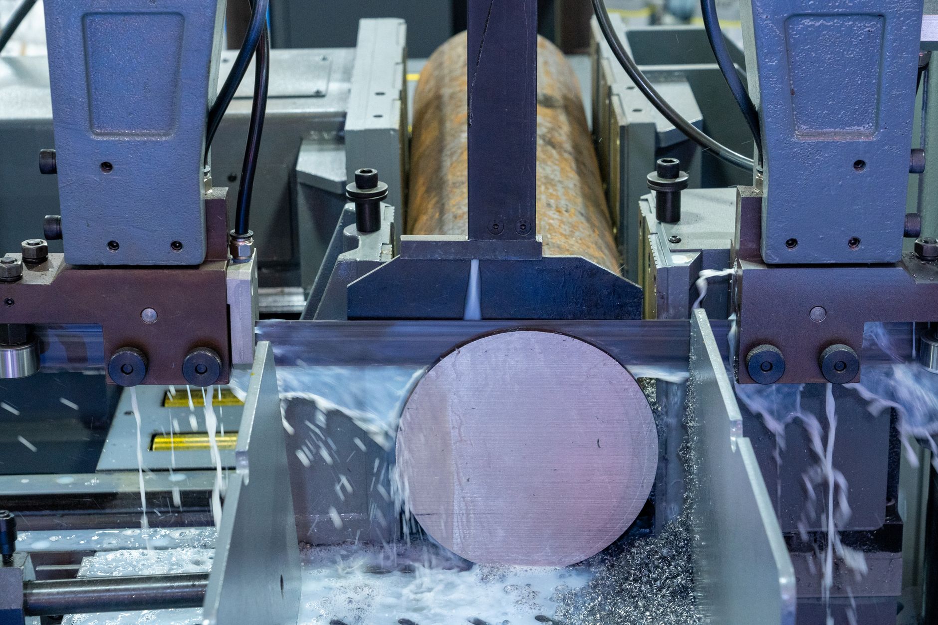 Horizontal photo of a metal cutoff saw station handling short-run stock, illustrating one of the first repetitive handoffs a cobot can simplify.