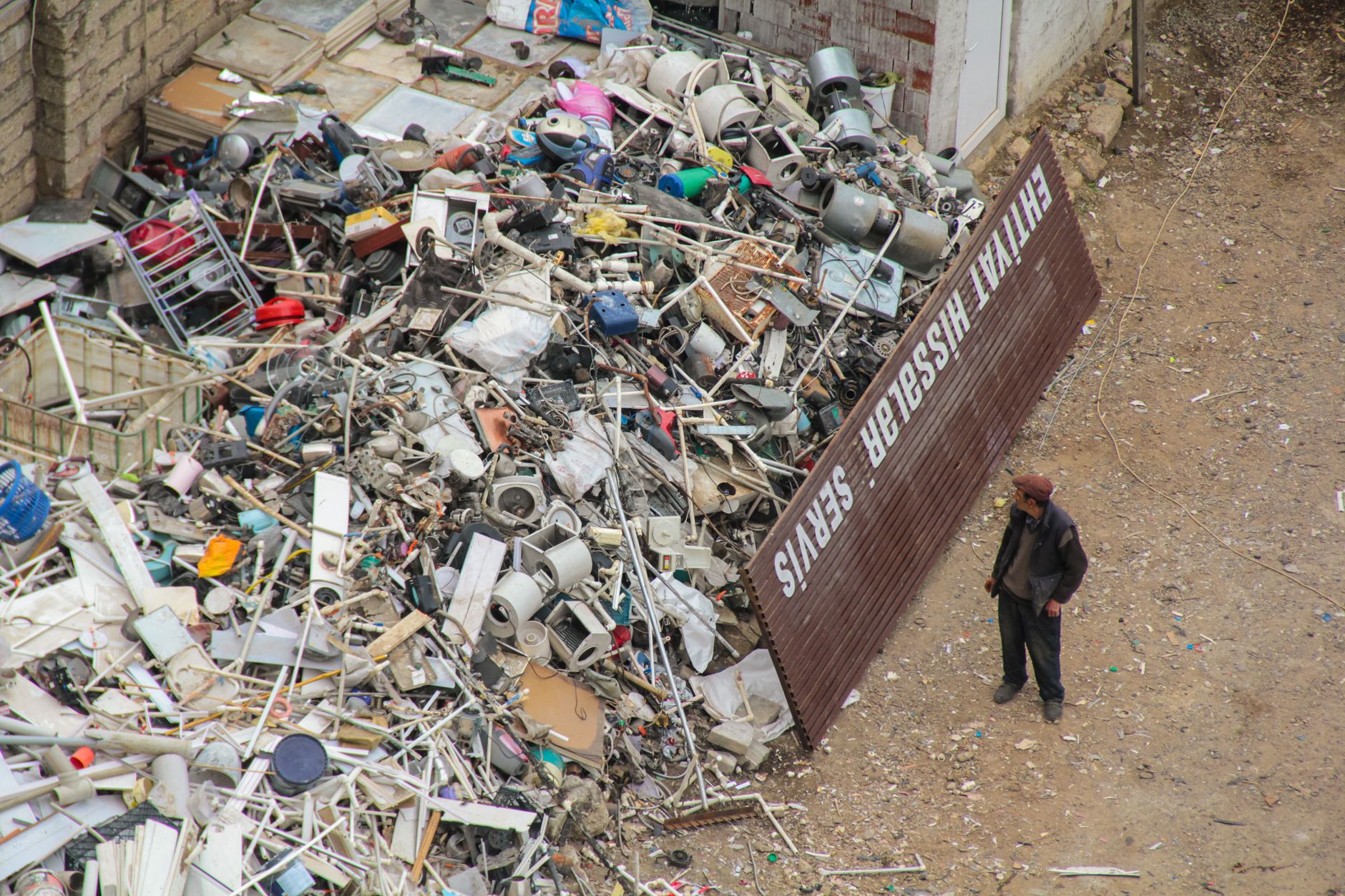 Workers sort discarded electronics inside a prepared e-waste recycling facility.
