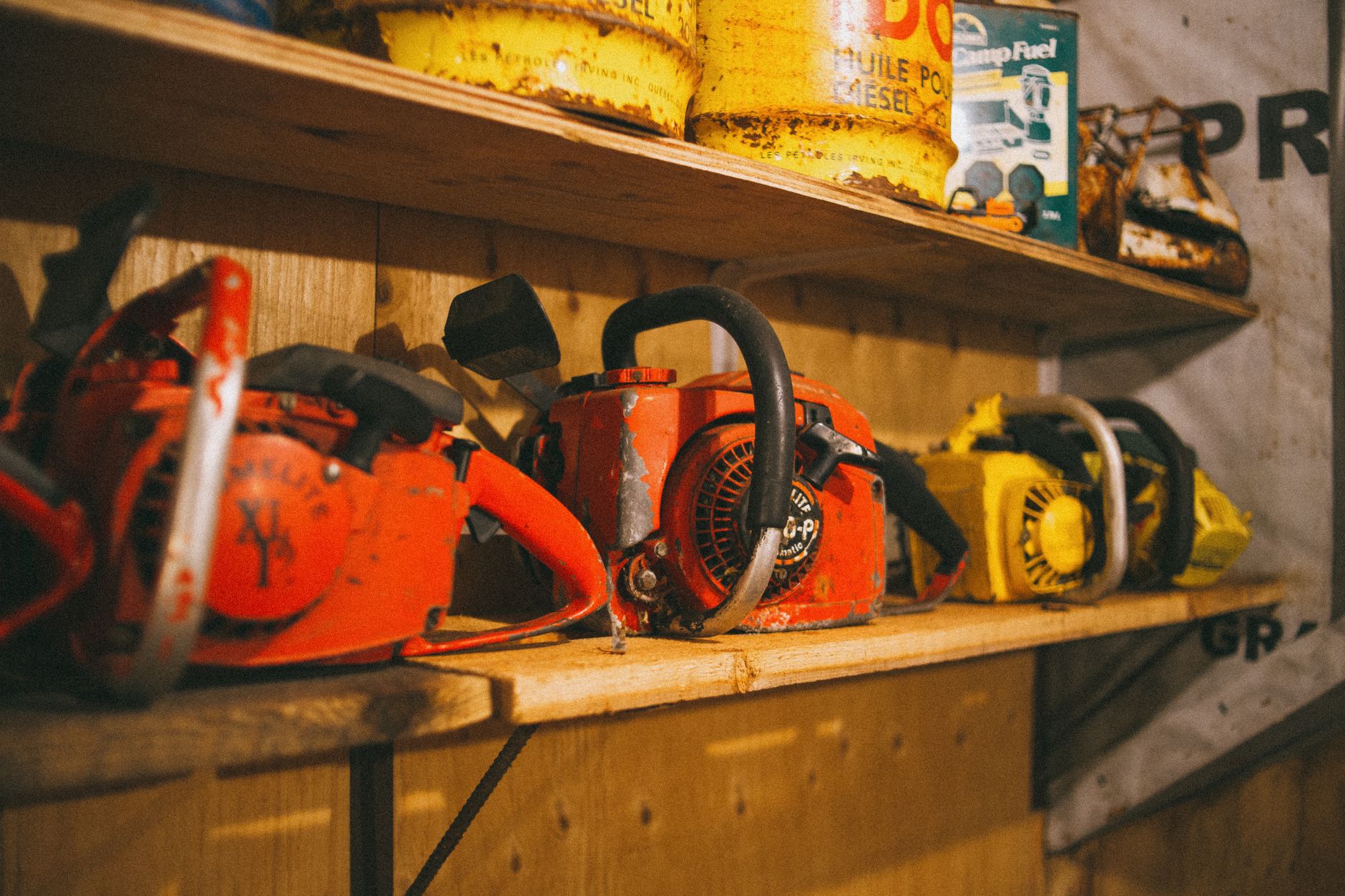 Power tools on storage shelves, illustrating mixed rental SKUs at return intake.