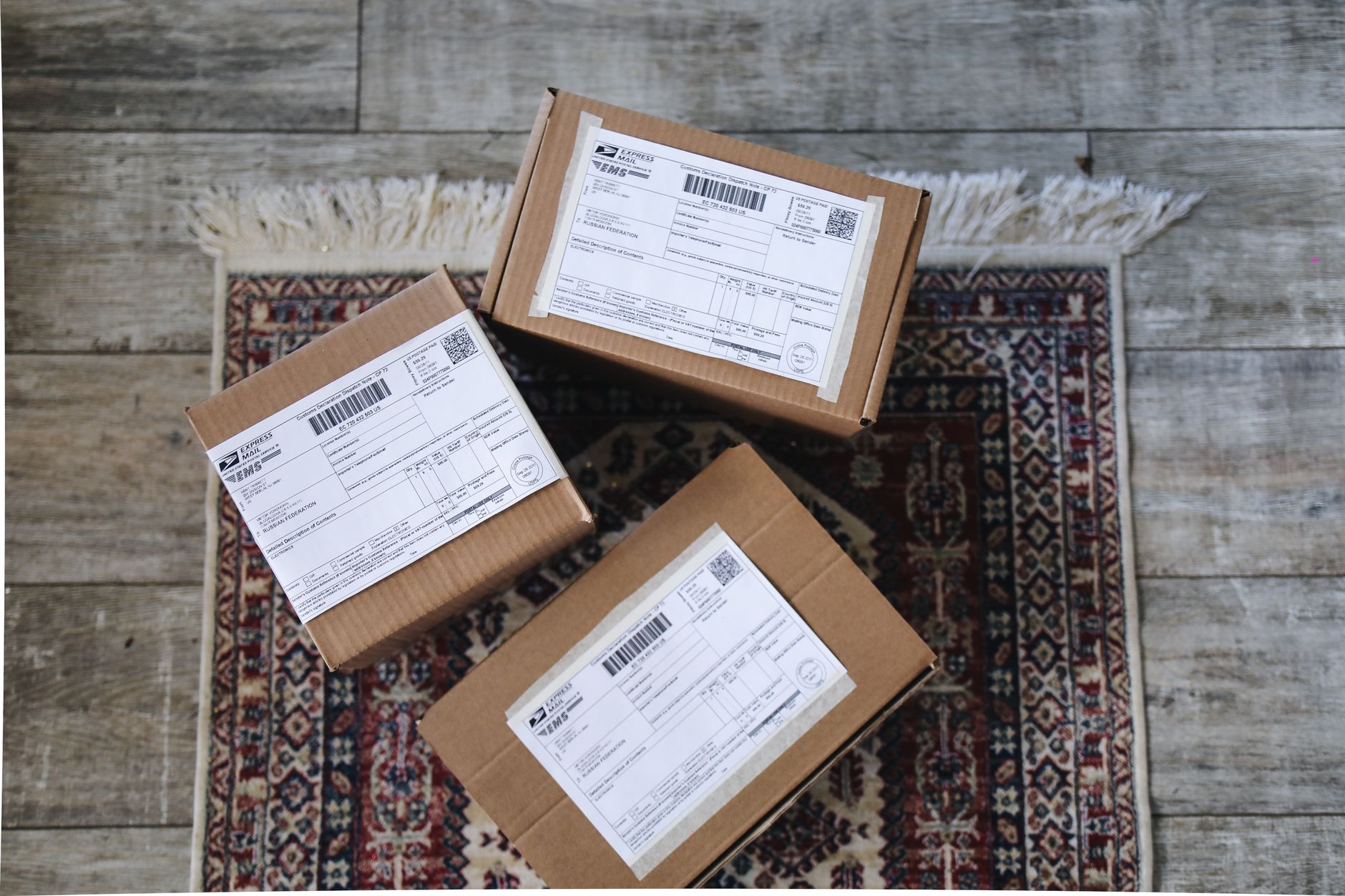 Labeled boxes at an intake station where asset tags drive sort lanes.