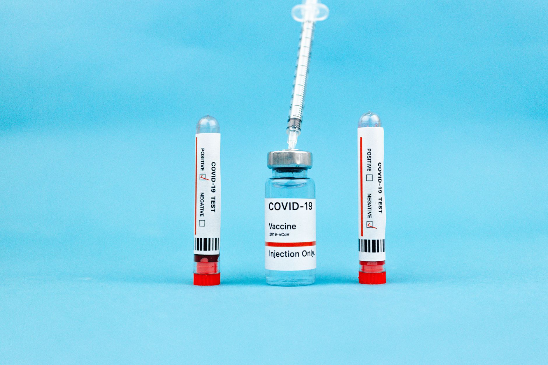 Sheets of medical barcode labels and labeled components are laid out for verification before a kit pouch or tray is closed.