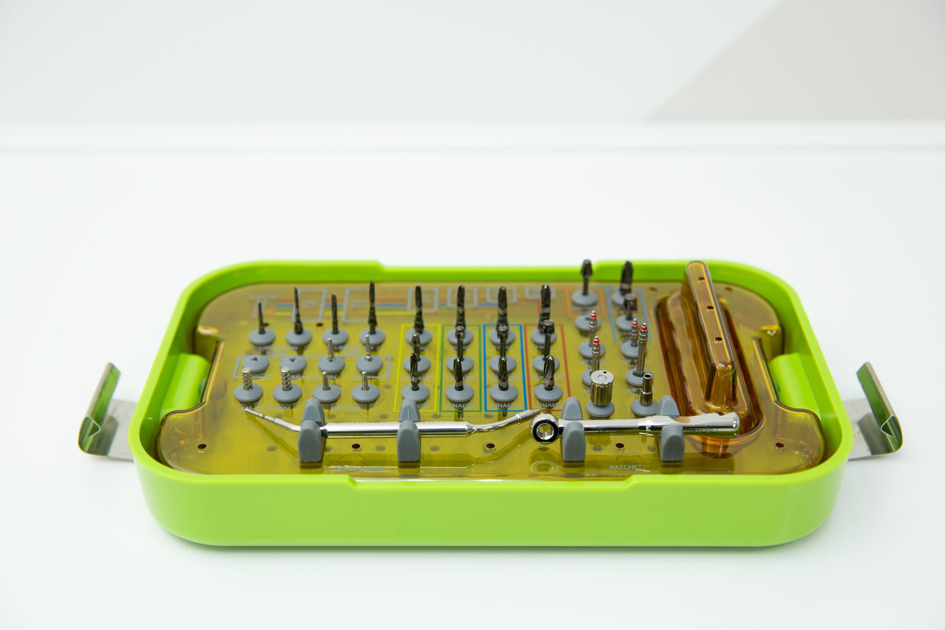 Gloved workers arrange medical components into trays on a clean worktable before the packages are sealed and terminally sterilized.
