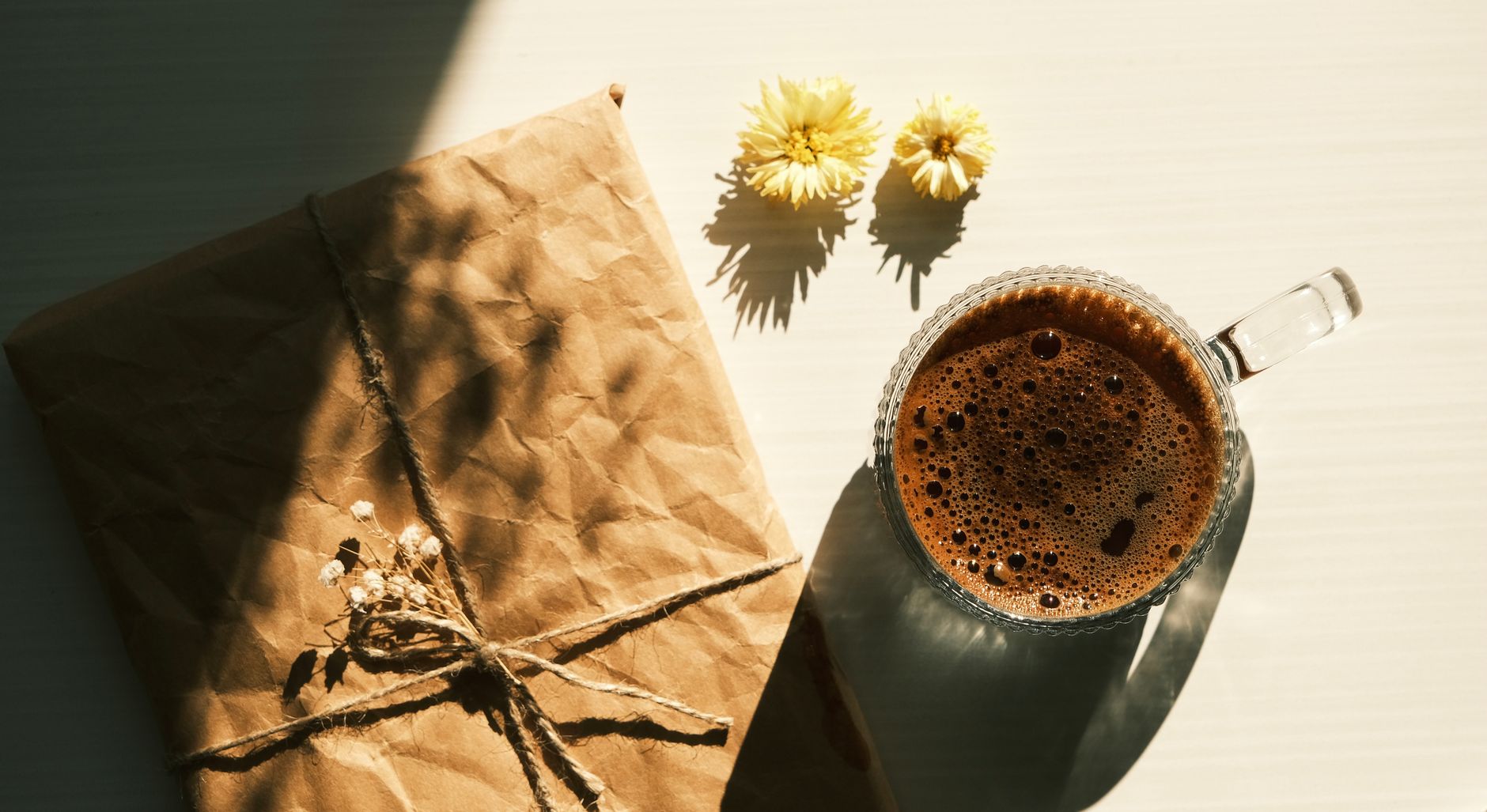 Kraft coffee bags at a packing bench, showing how film stiffness changes after fill.
