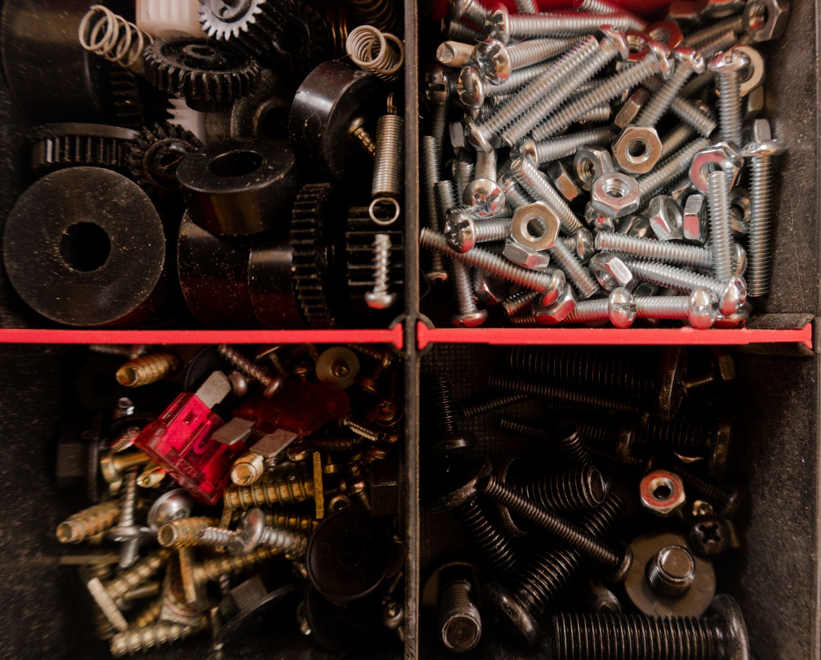 Organized metal blanks in a staging tray, matching repeatable infeed for automated wire EDM loading.