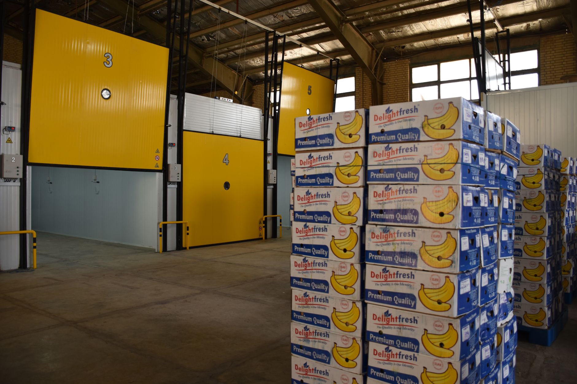 Interior of a food processing warehouse with stacked bagged goods on pallets
