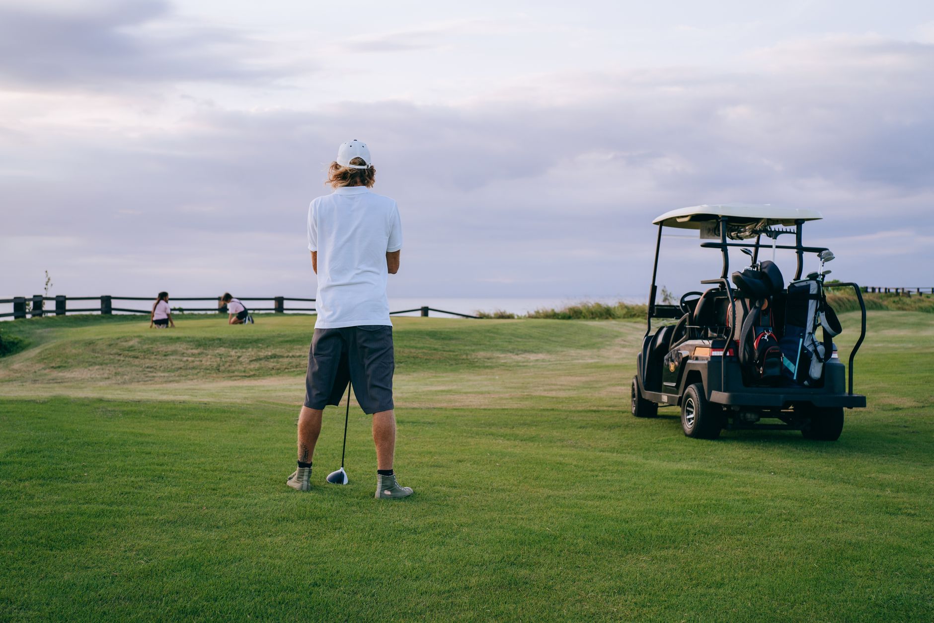 Outing carts lined up as staggered tee times begin.