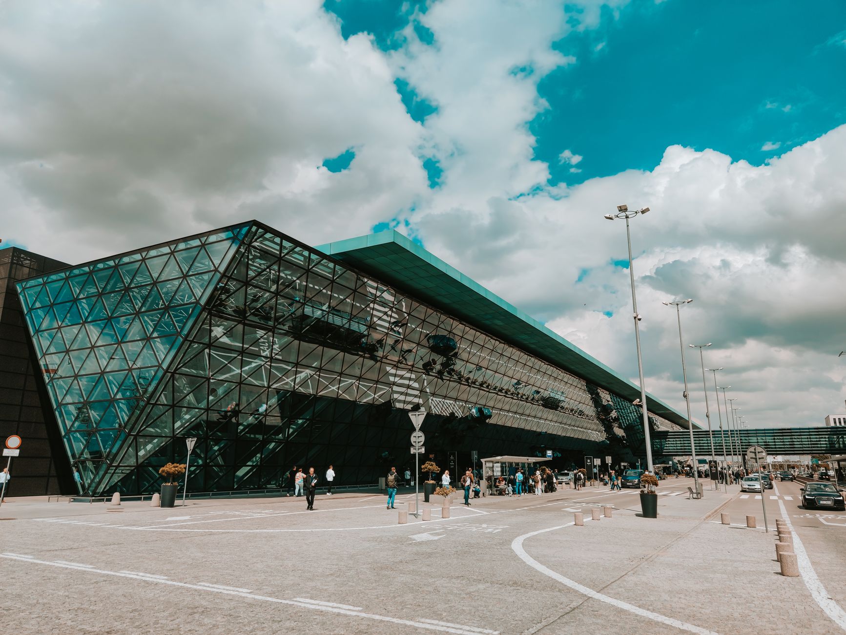 A wide, bright, and modern airport terminal with travelers, conveying the busy public space managed at CVG.