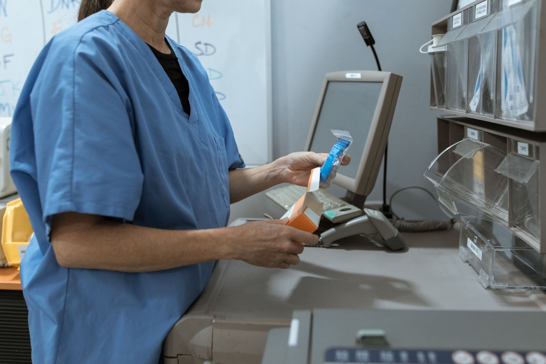 A hospital pharmacy workspace where prescriptions are verified, packaged, and prepared for outbound delivery.