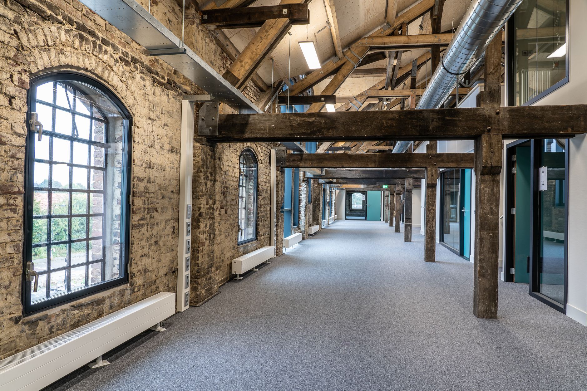 A hospital corridor under renovation, showing the disruption older facilities face when infrastructure work happens in occupied spaces.