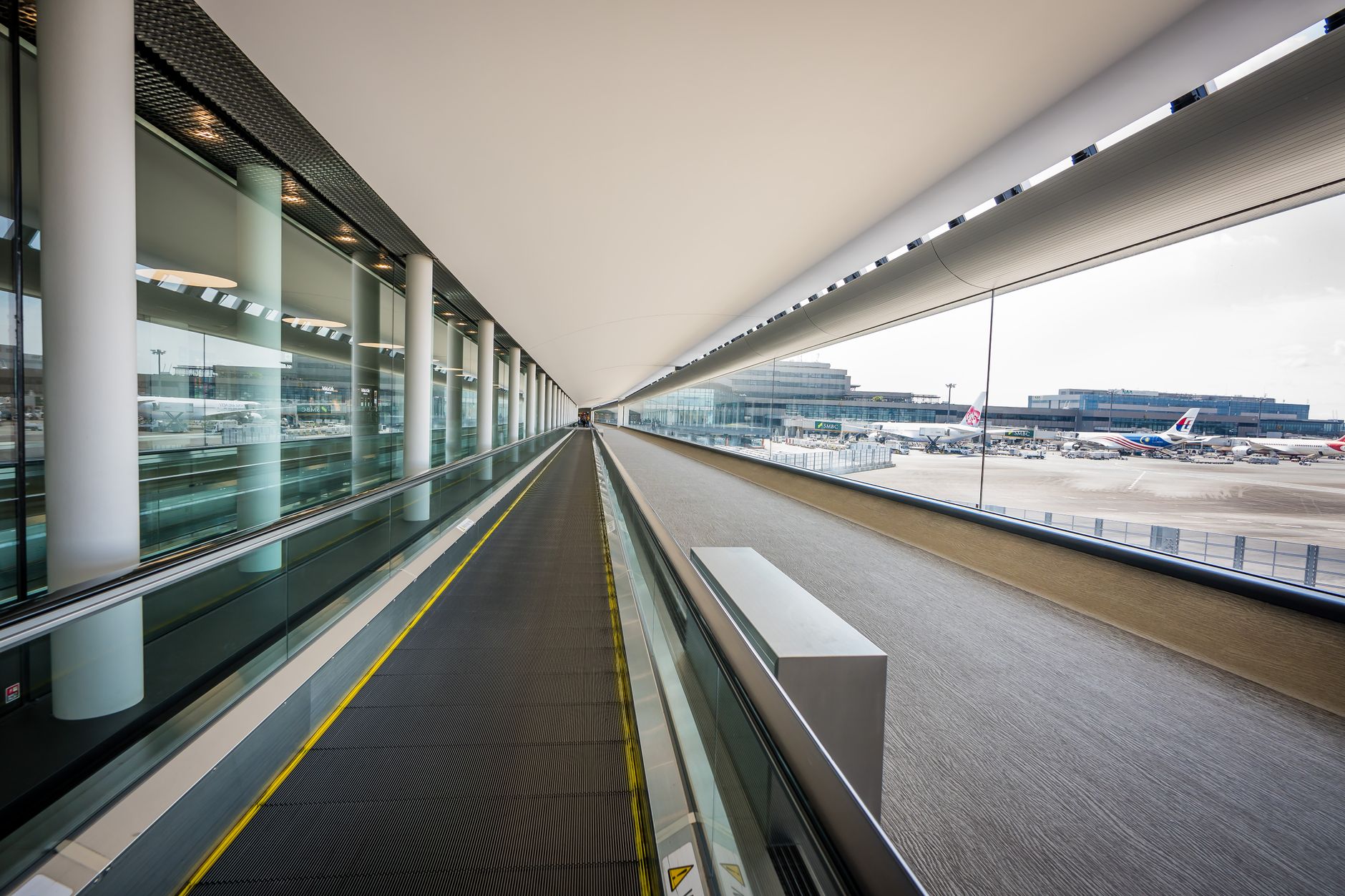 A busy public walkway in a terminal, a setting for live route tests with handlers and mobility device users.