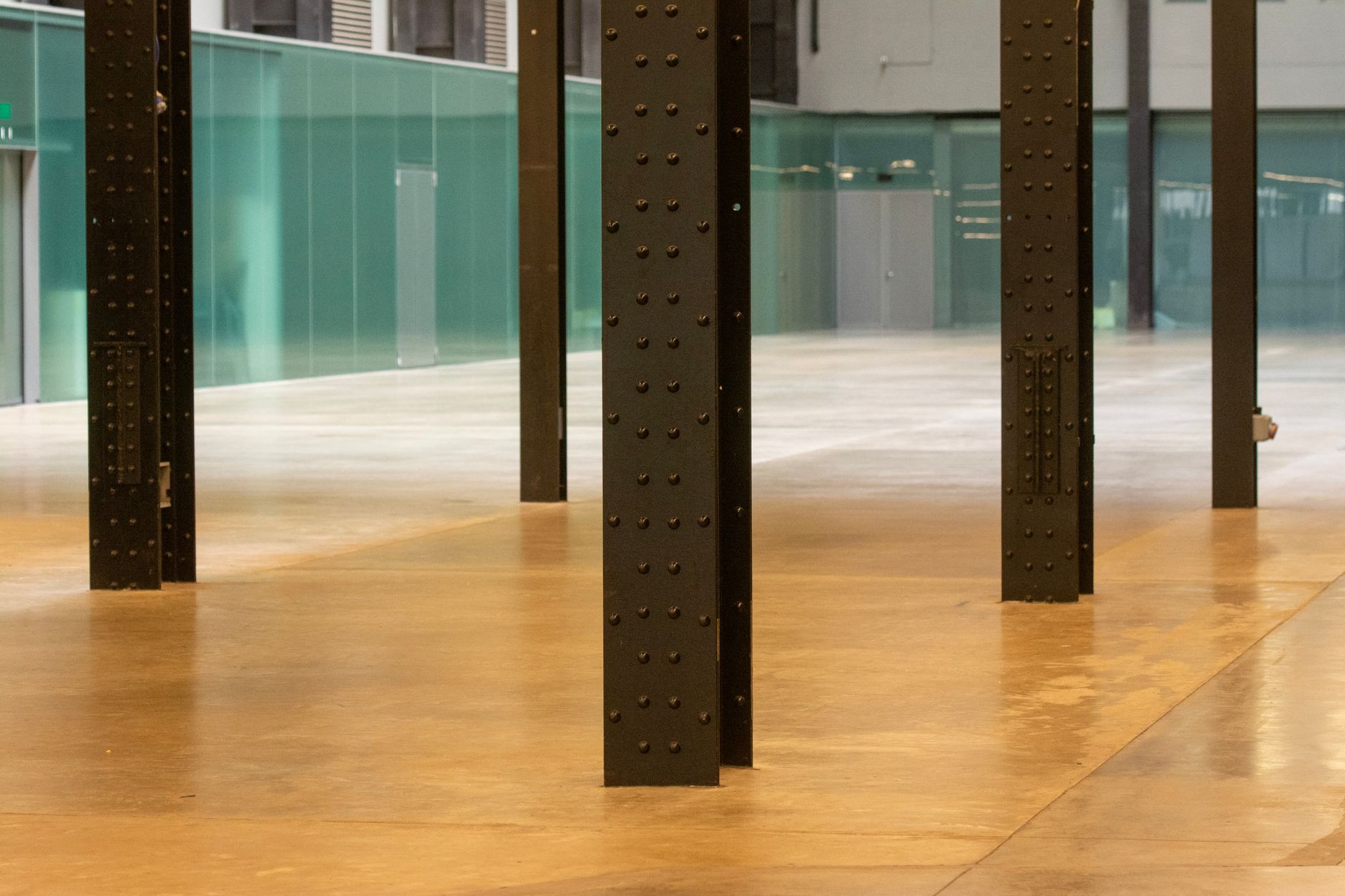 An expansive, polished concrete floor in a large commercial building, illustrating the type of large-scale cleaning task suitable for an autonomous floor scrubber.