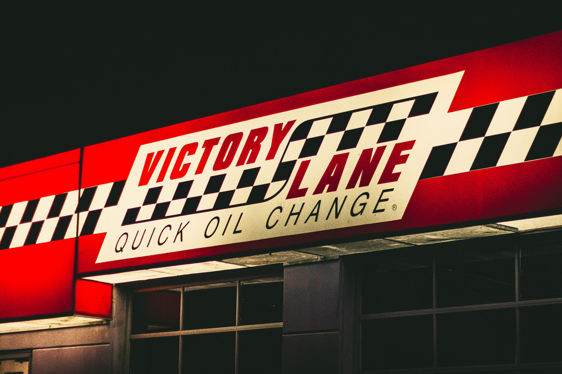 A clean quick-lube service center with customer areas beside the vehicle service bays.