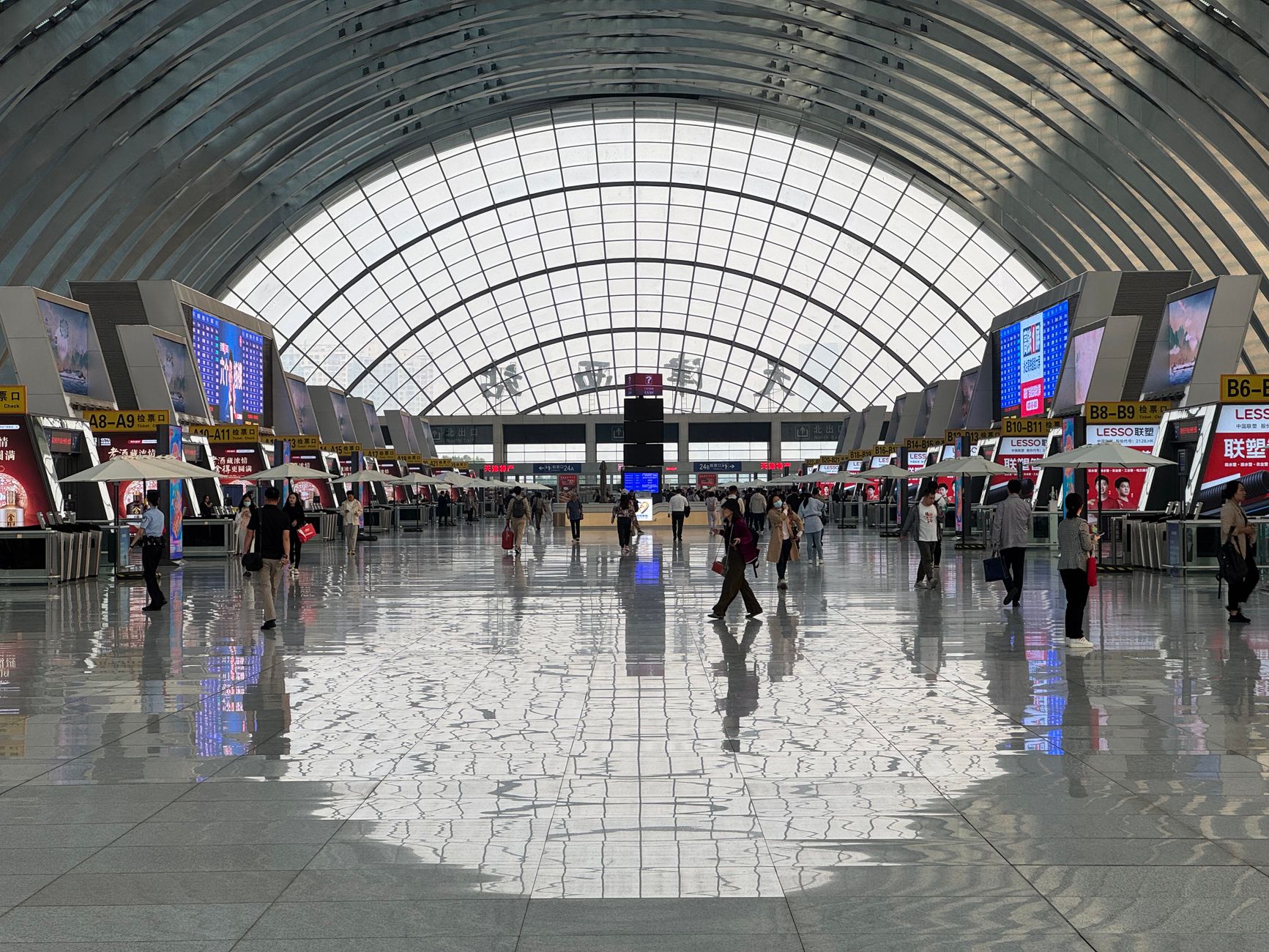 Passengers walking through a crowded airport terminal