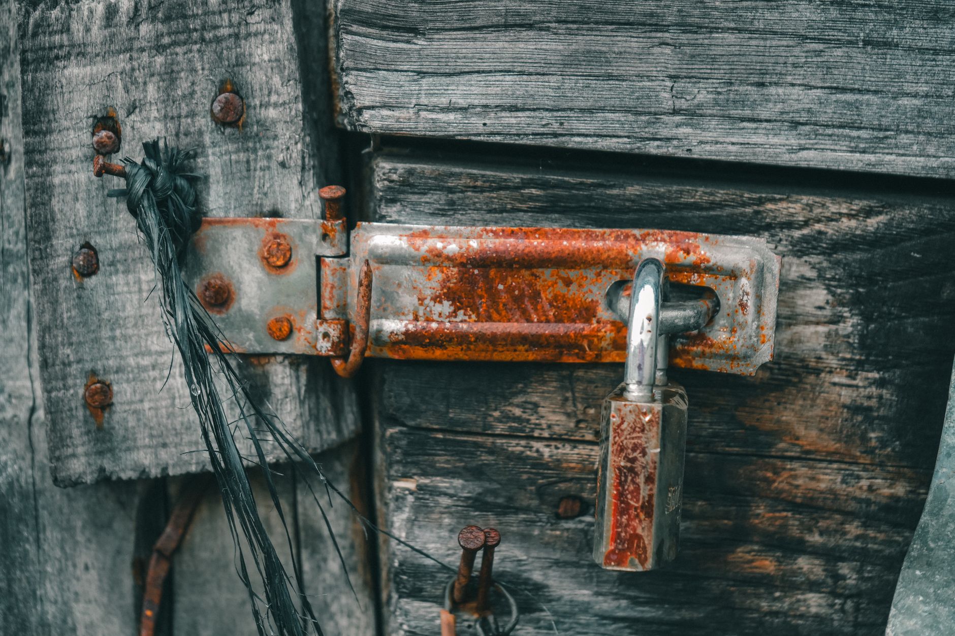 Rust and residue around a metal doorway threshold illustrating the damage repeated chloride exposure can cause.