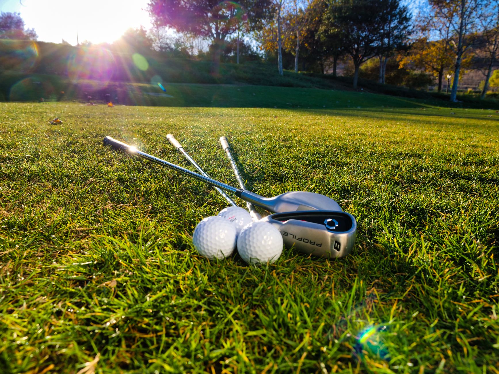 Morning league golfers on a fairway when four-ball play keeps two balls active on shared corridors.