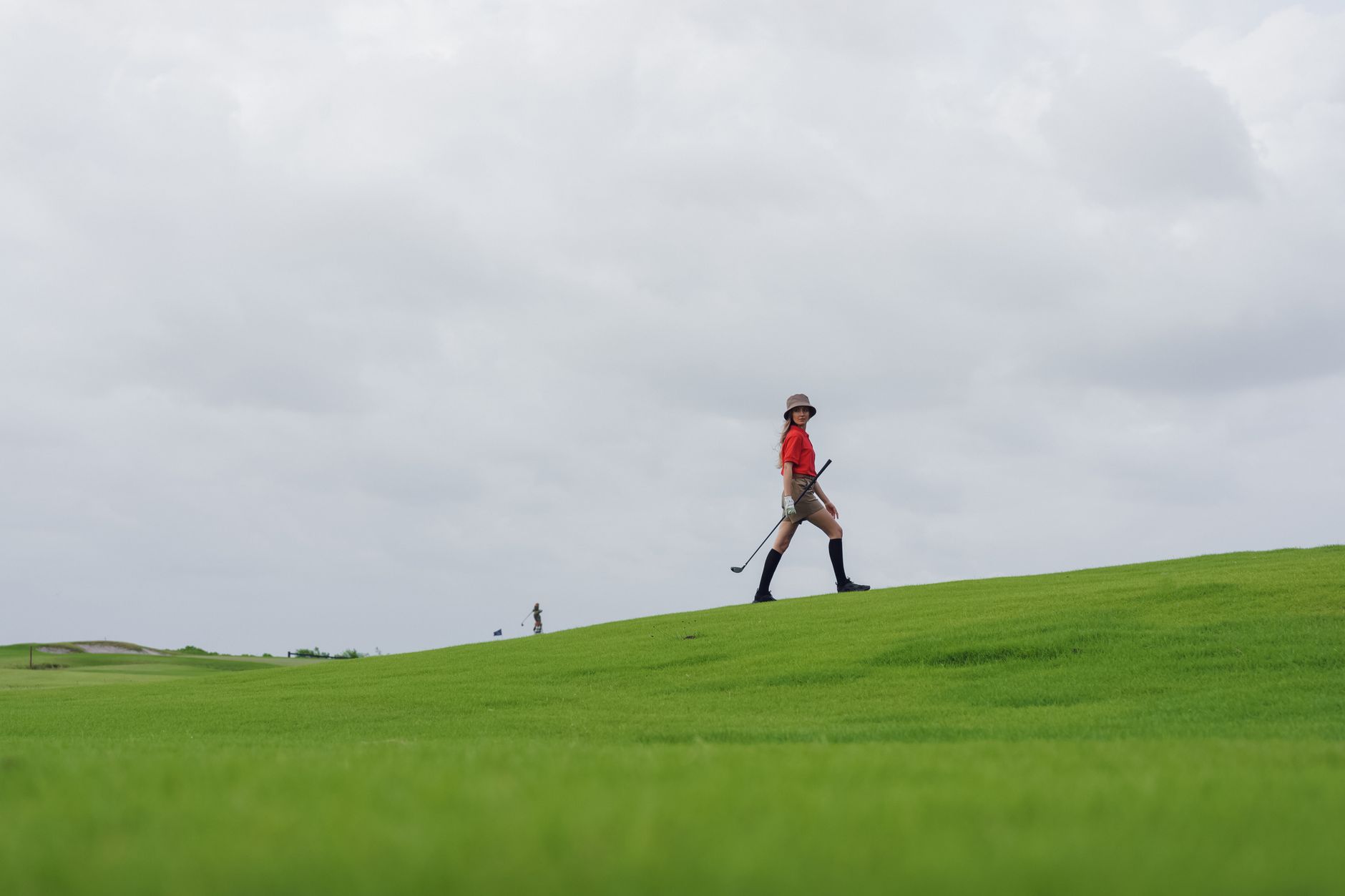 Superintendent walking fairway turf to inspect conditions