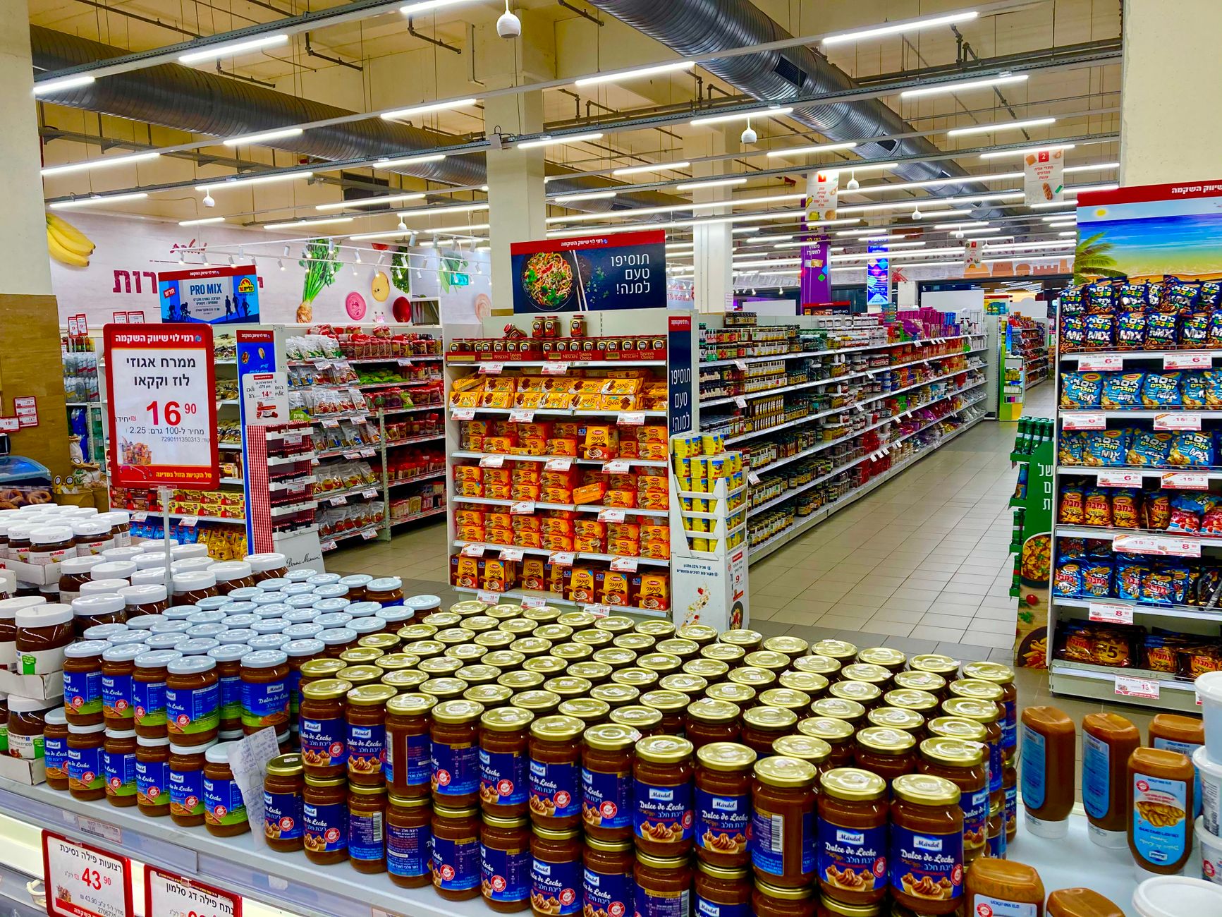 A supermarket interior where mixed autonomous scrubbers can cover wide aisles and tighter lanes.