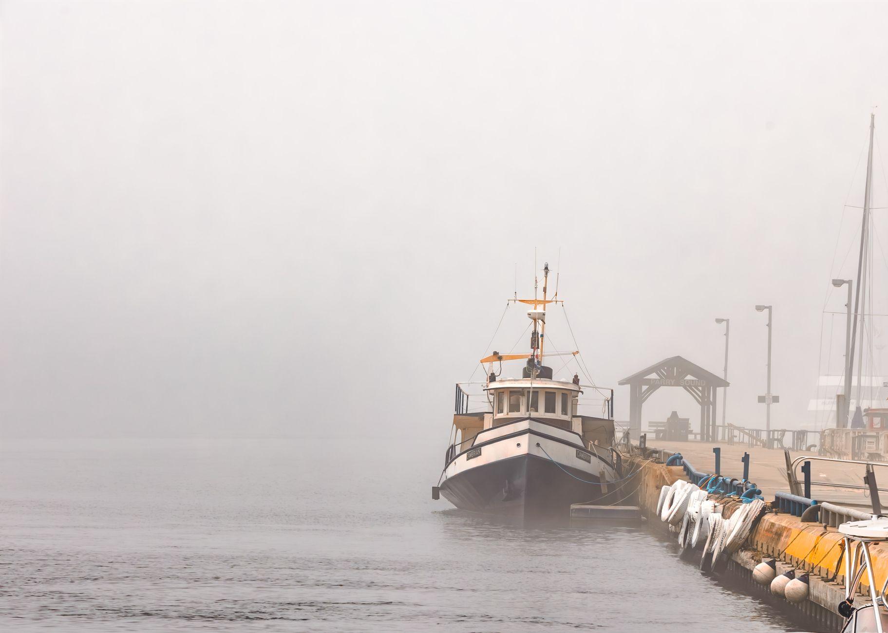 Foggy harbor waterfront with industrial buildings