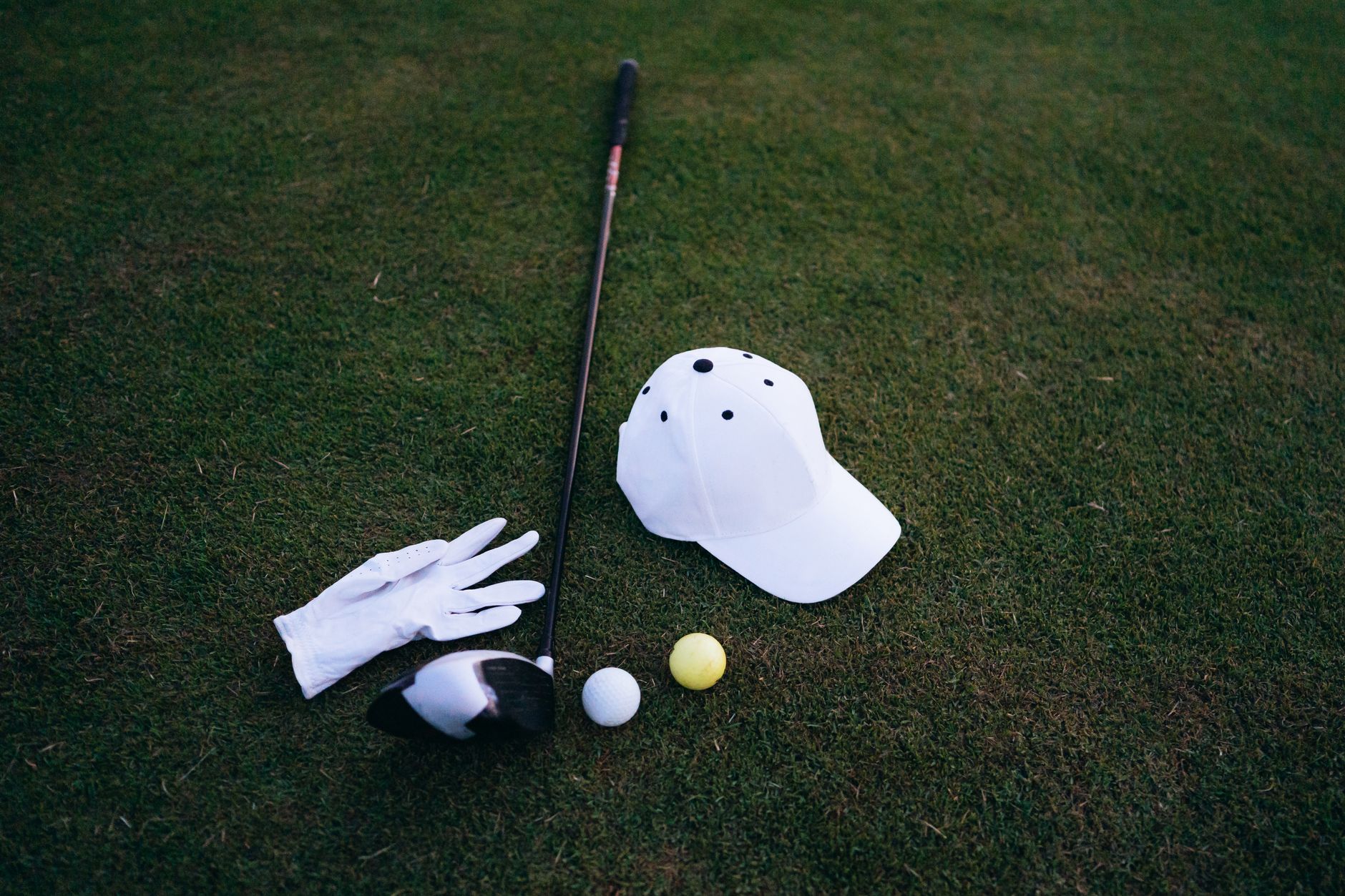 High school golfers during an afternoon match on a fairway.