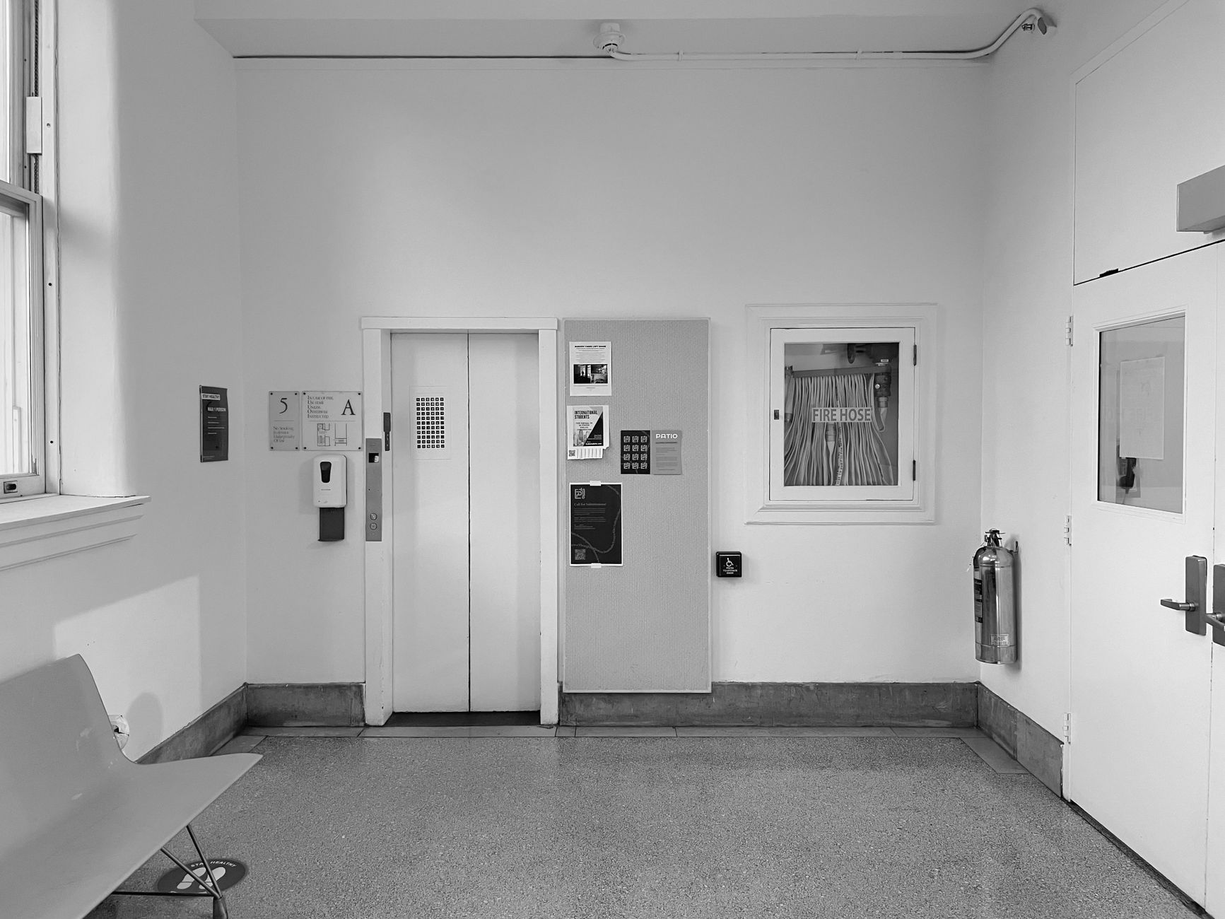 Hospital elevator bank with closed doors and wall signage