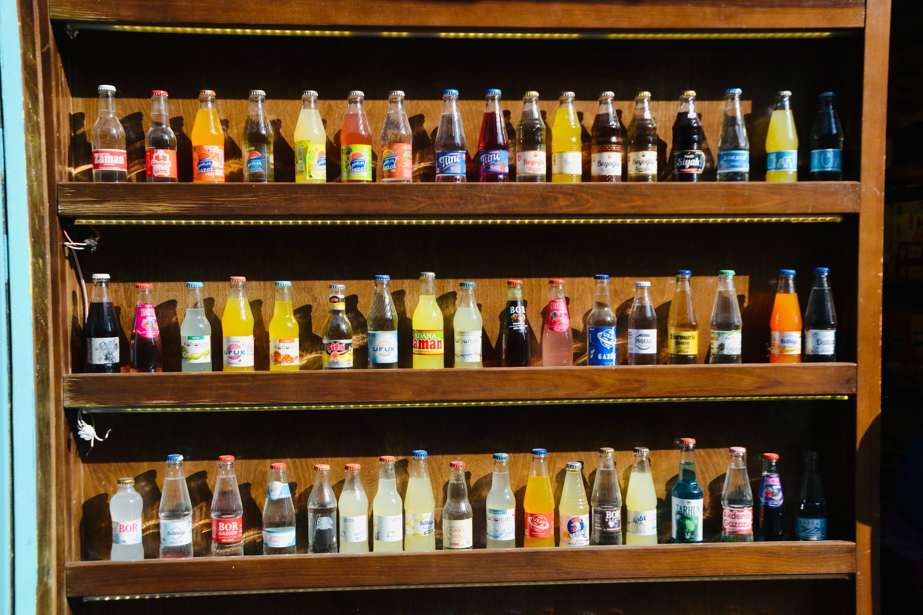 Bottled beverages are organized on storeroom shelves for secure packing into floor-specific minibar totes.