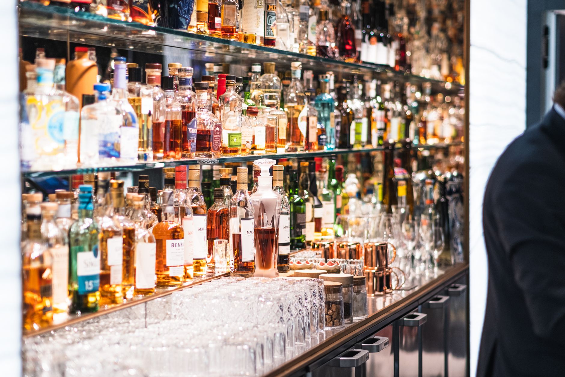 A well-stocked hotel minibar displays sealed drinks and snacks ready for replenishment.