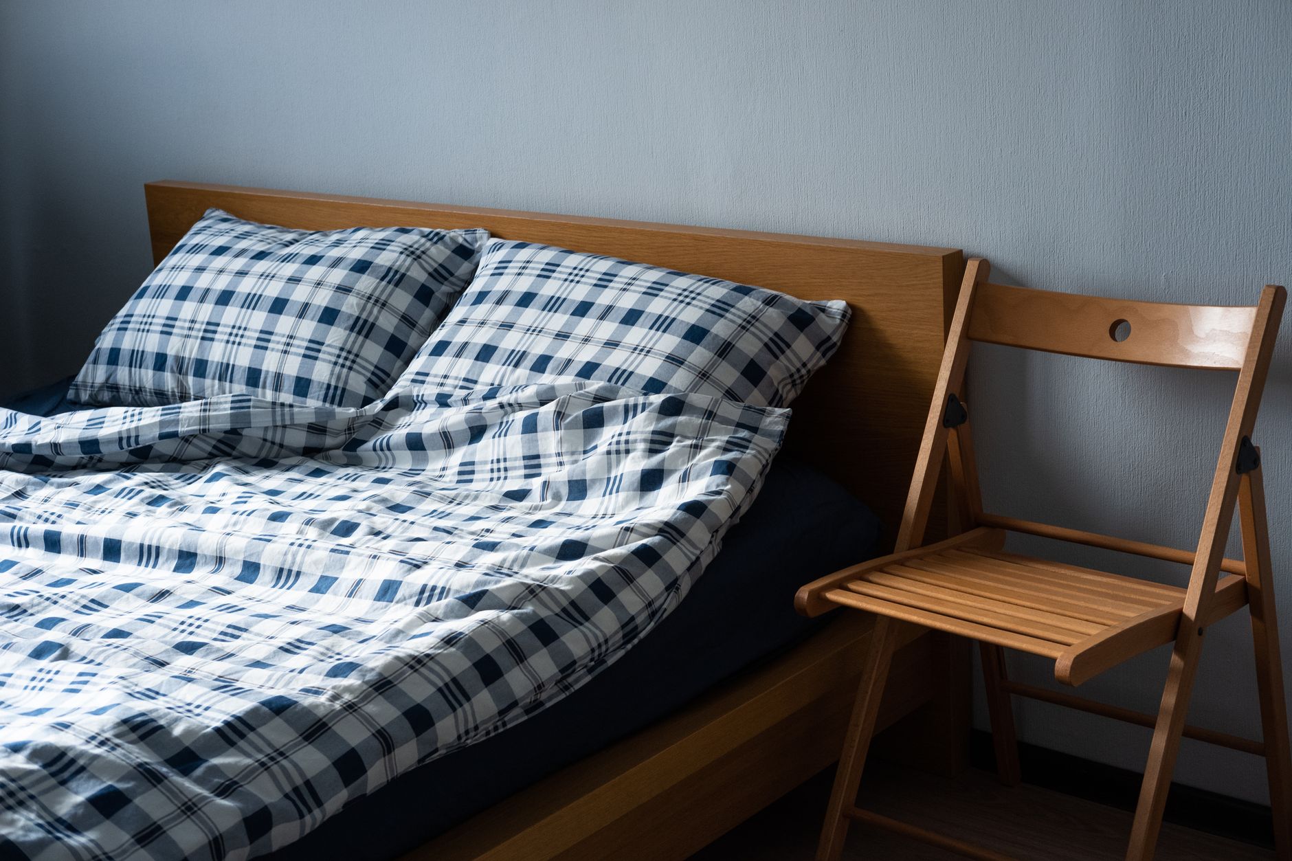 A folded rollaway-style mattress and frame similar to bulky guest equipment moved on a housekeeping cart.