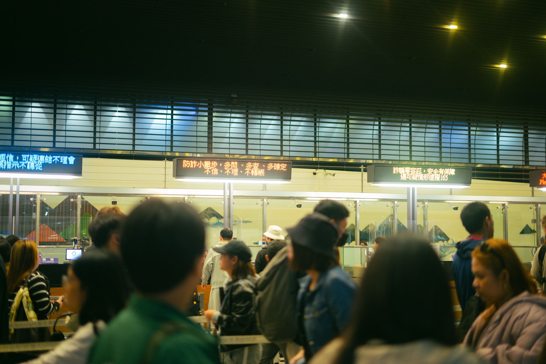 Passengers moving through a terminal queue, illustrating the crowd conditions and edge cases that make public-risk planning essential.