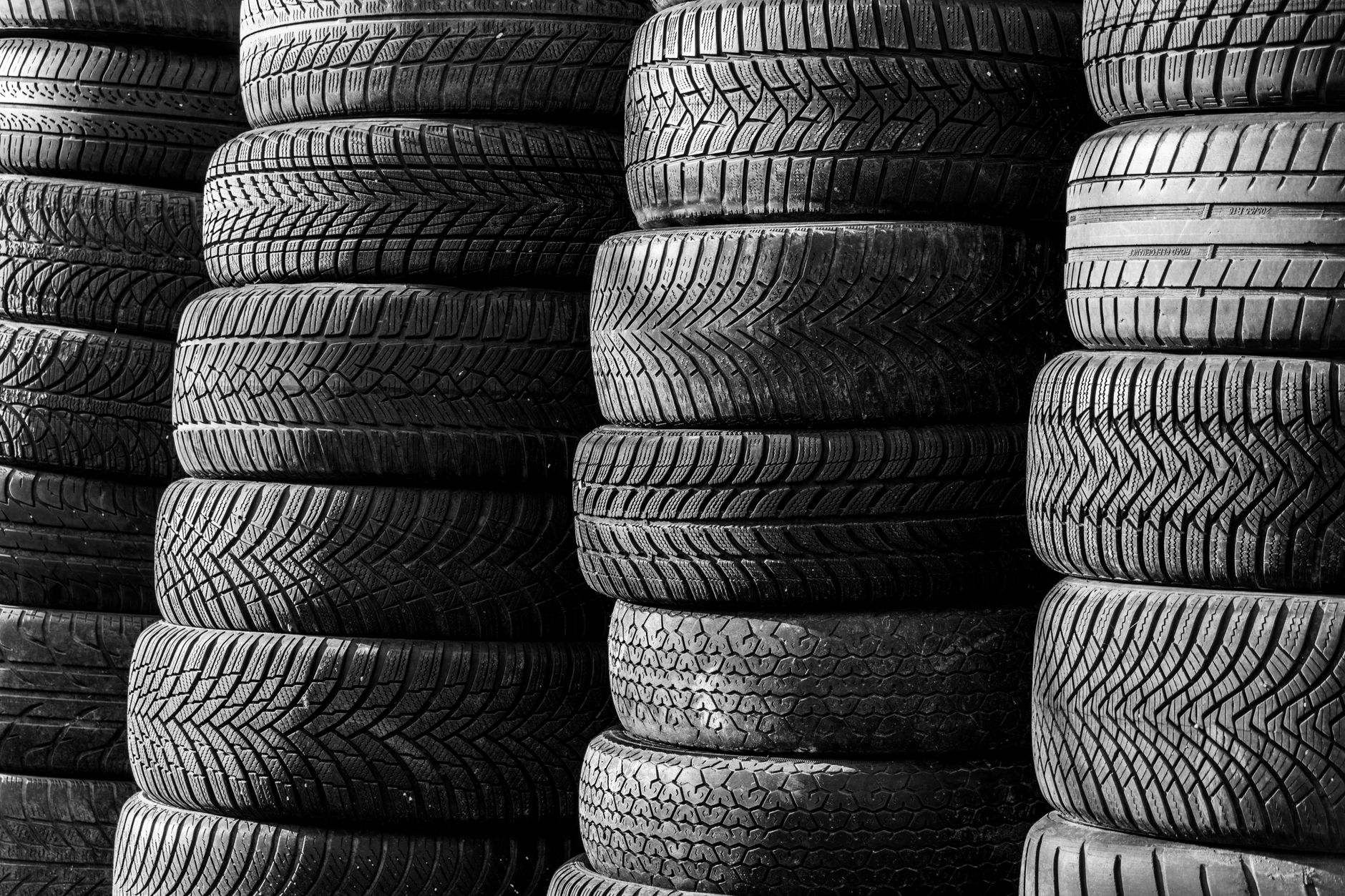 Mixed-size tires stacked together, showing why tire loads need restraint during transport.