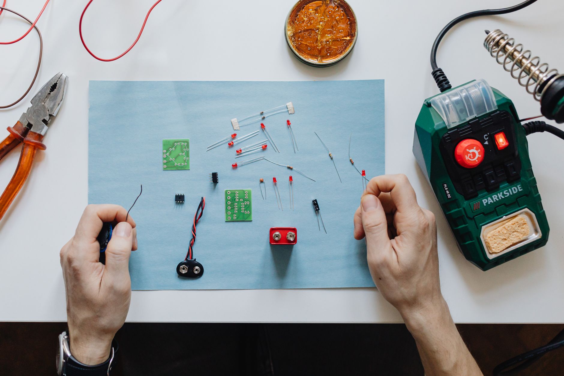 A skilled worker focuses on a complex assembly task at their station, showing the value-added work that is prioritized when AMRs handle material movement.