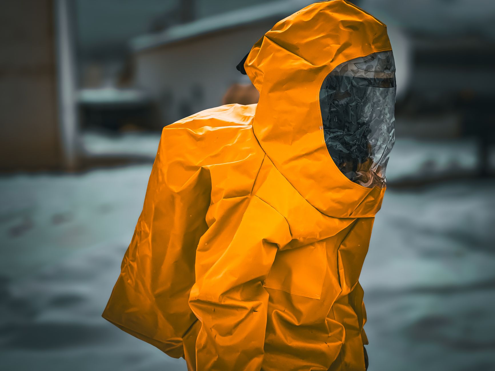 A worker wearing a heavy-duty insulated freezer suit, highlighting the extreme conditions in a cold storage facility that automation helps mitigate.