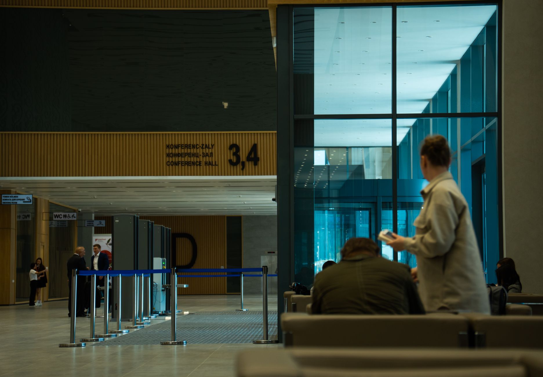 A bank-like interior monitored by visible security cameras, reflecting controlled public and semi-public floor zones.