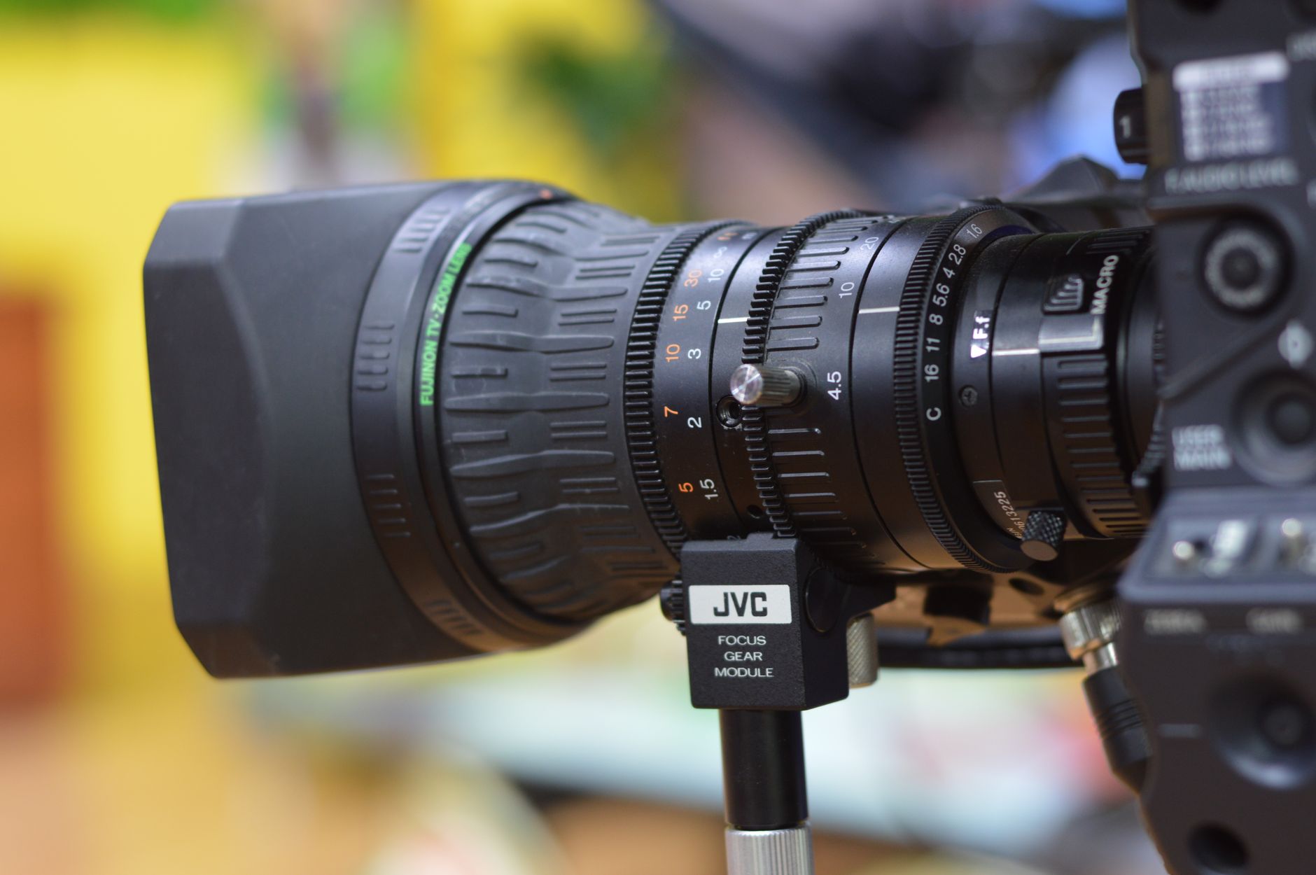 A close-up view of a high-resolution industrial camera lens, a key technology that gives collaborative robots the ability to 'see' and inspect products.