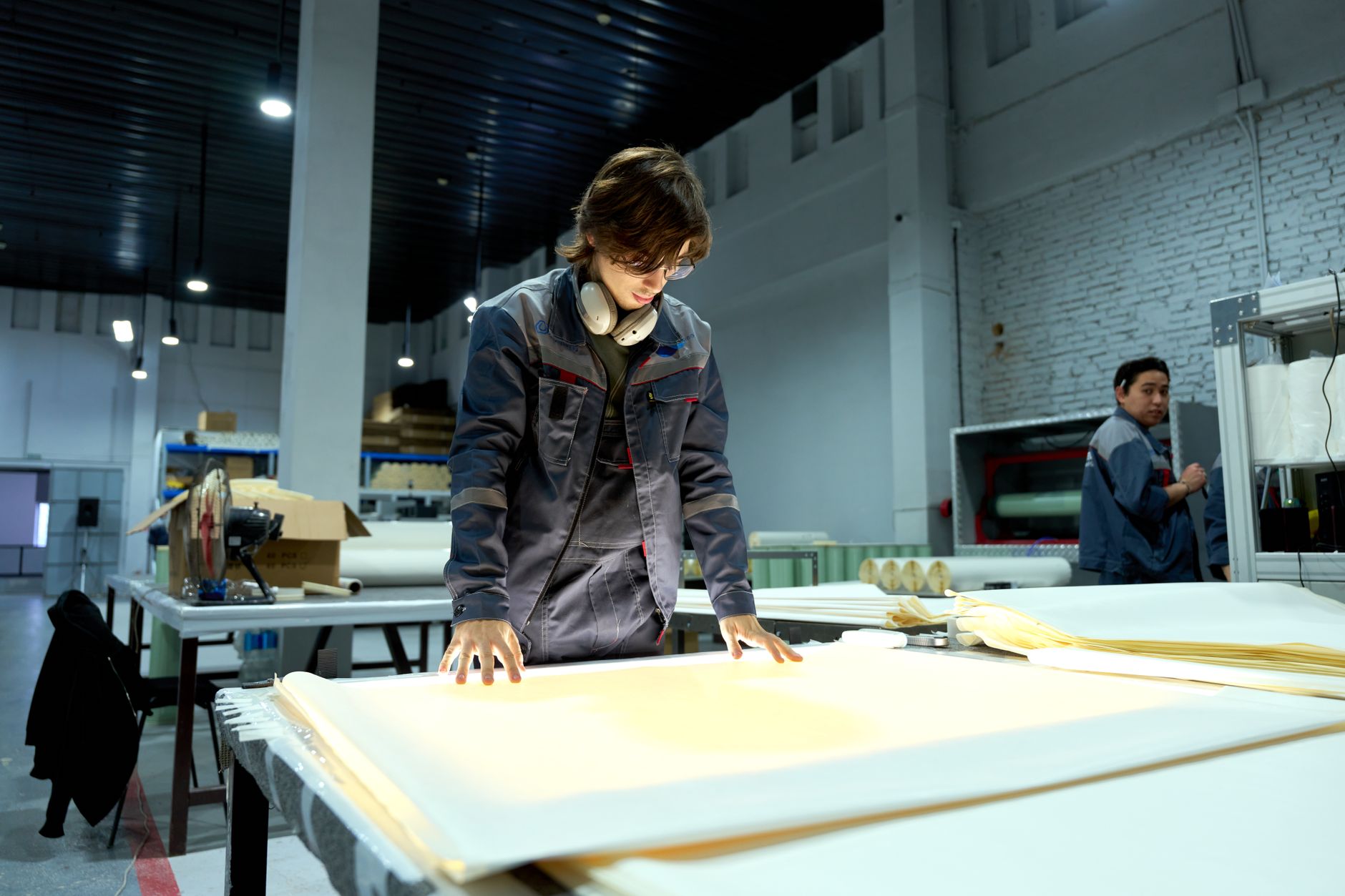 Operator-side inspection and rework area with parts staged on a factory table, matching the hands-on reality of a rework cell.