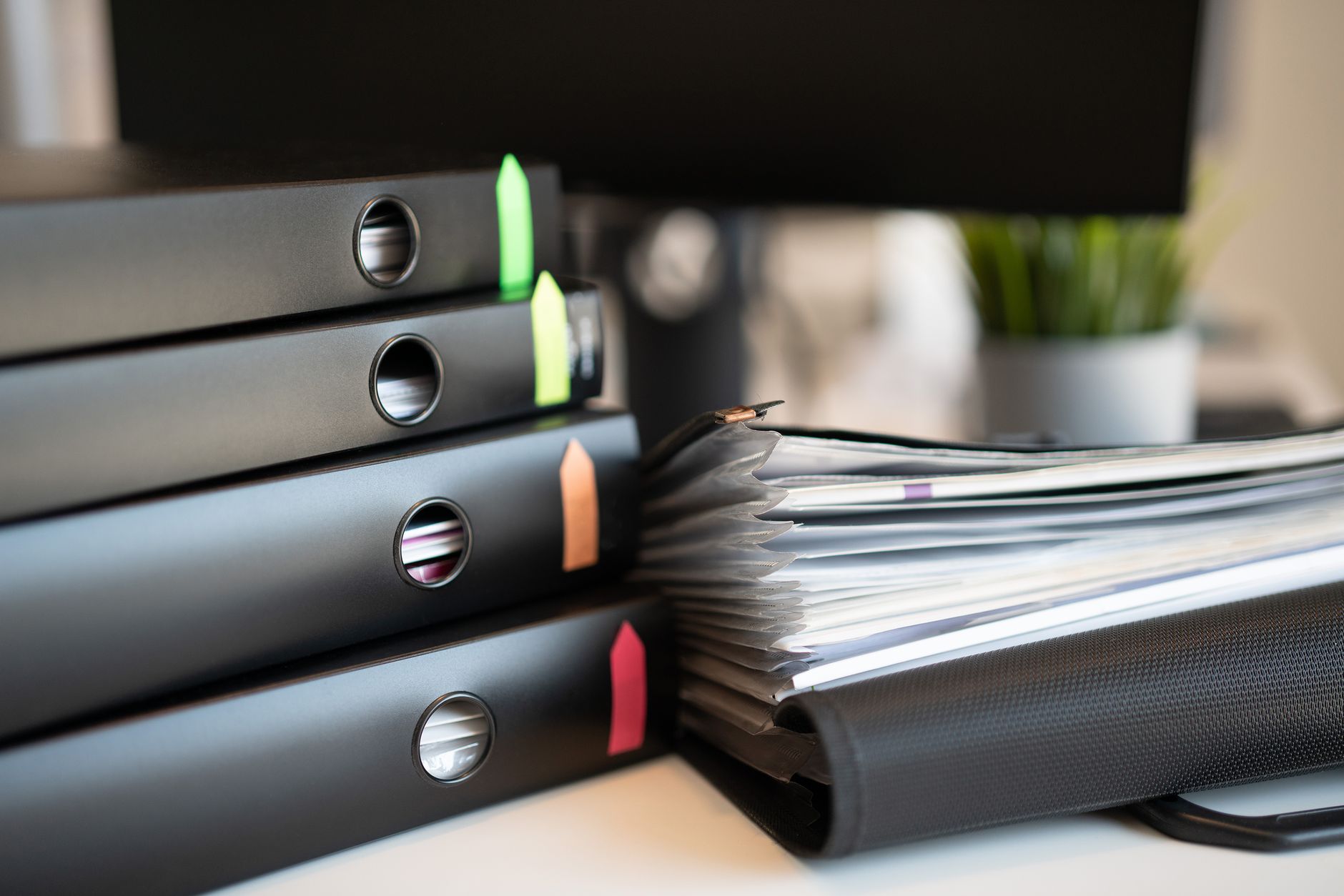 Binders and paperwork on a desk, illustrating formal solicitation packages for public purchases.