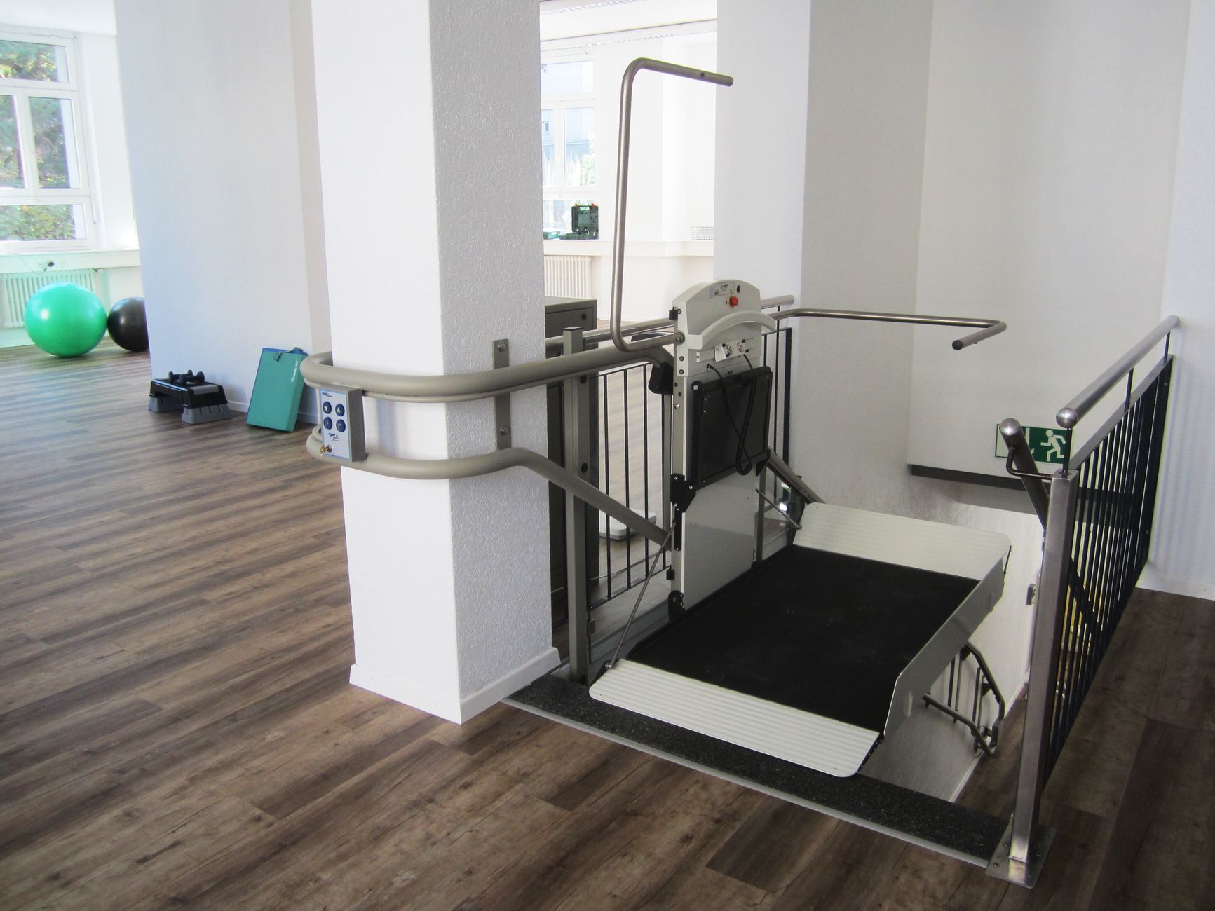 An accessible entrance ramp at a public building where robot routes must stay clear for visitors.
