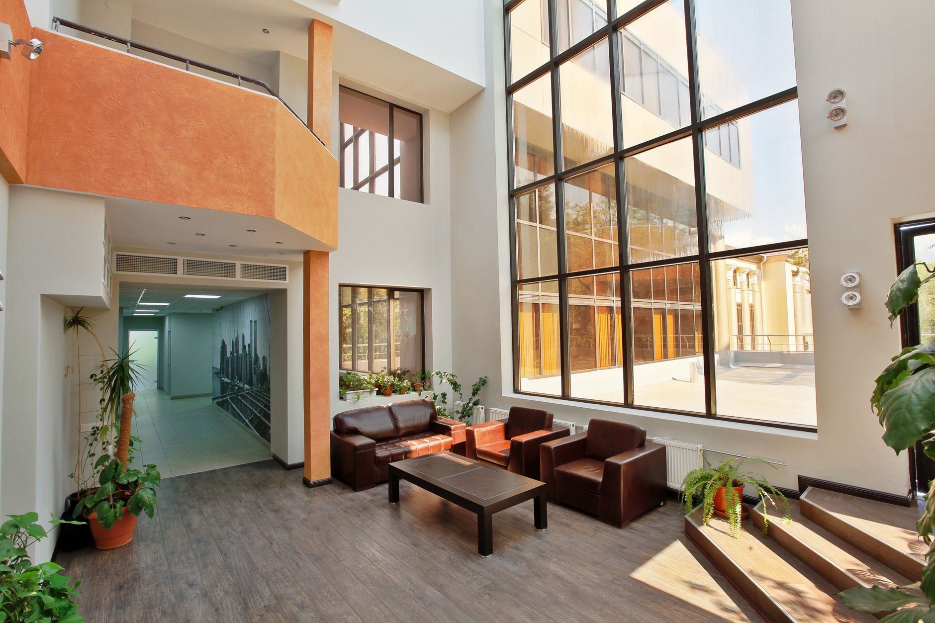 The bright, clean, and spacious lobby of a modern office building, which is maintained to LEED and WELL standards.