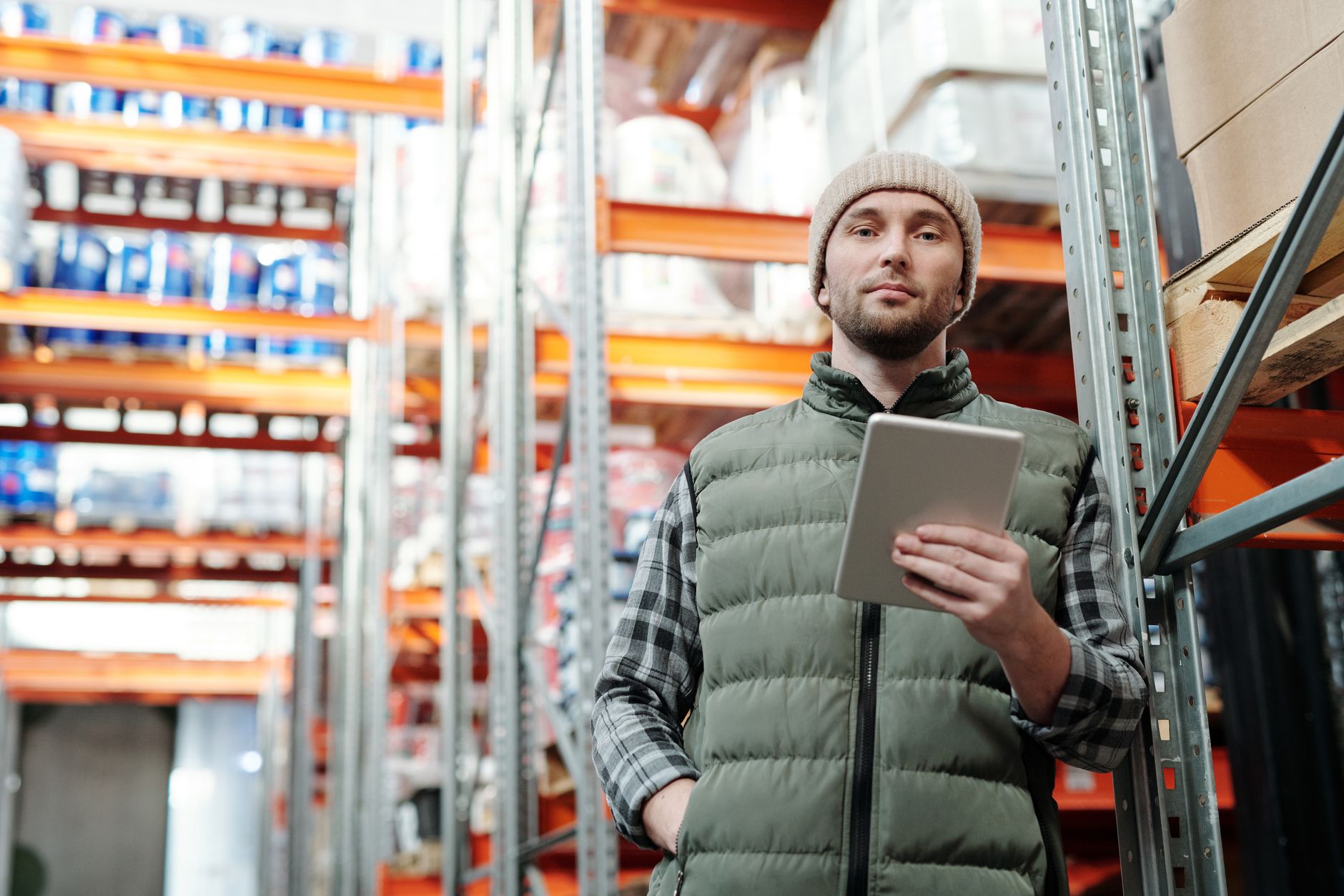 A manager reviews data on a tablet inside a large commercial facility, symbolizing centralized fleet management and oversight.