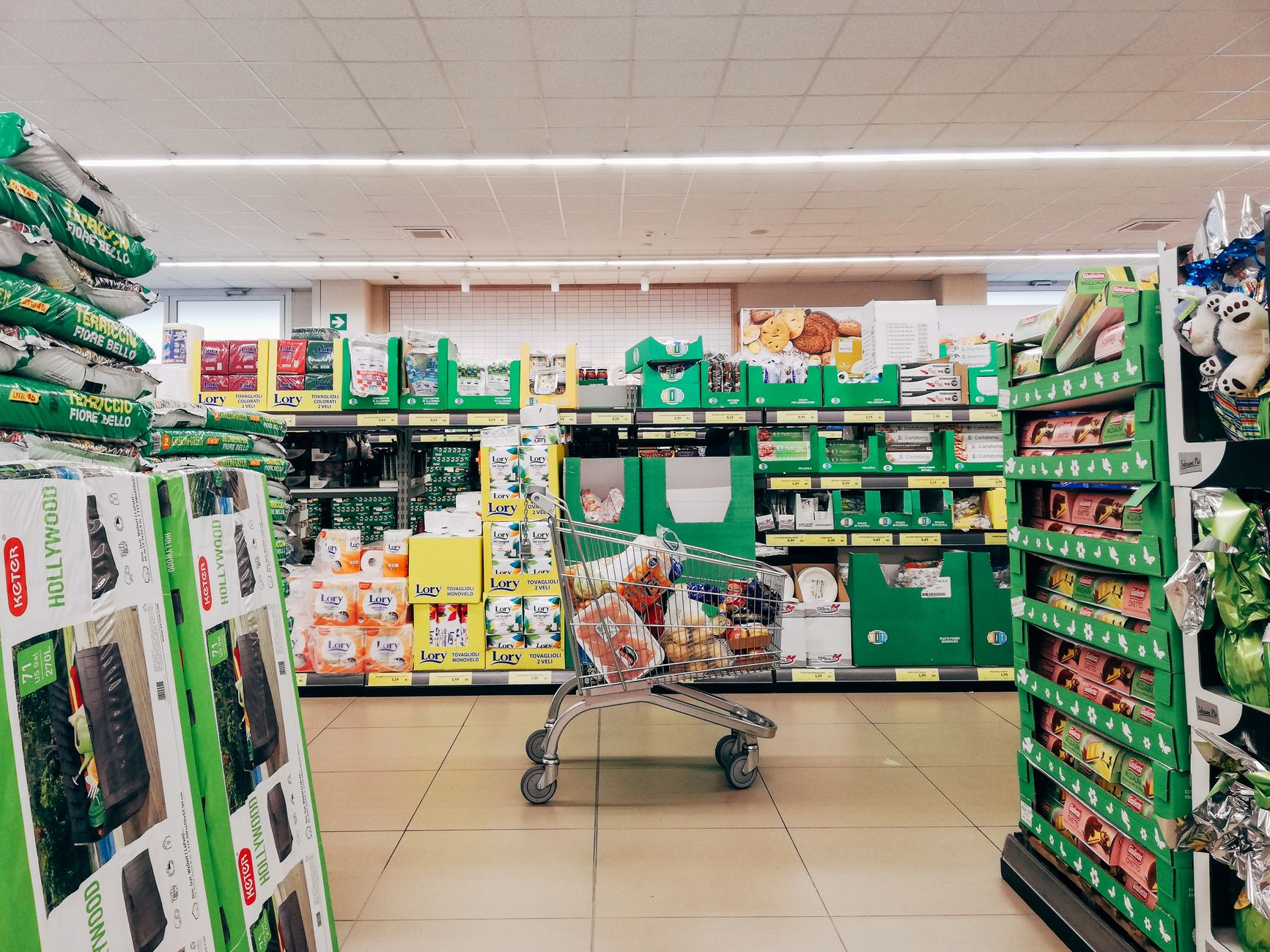 A pristine, brightly lit grocery store aisle with a polished floor, illustrating the high standard of cleanliness that impresses customers.