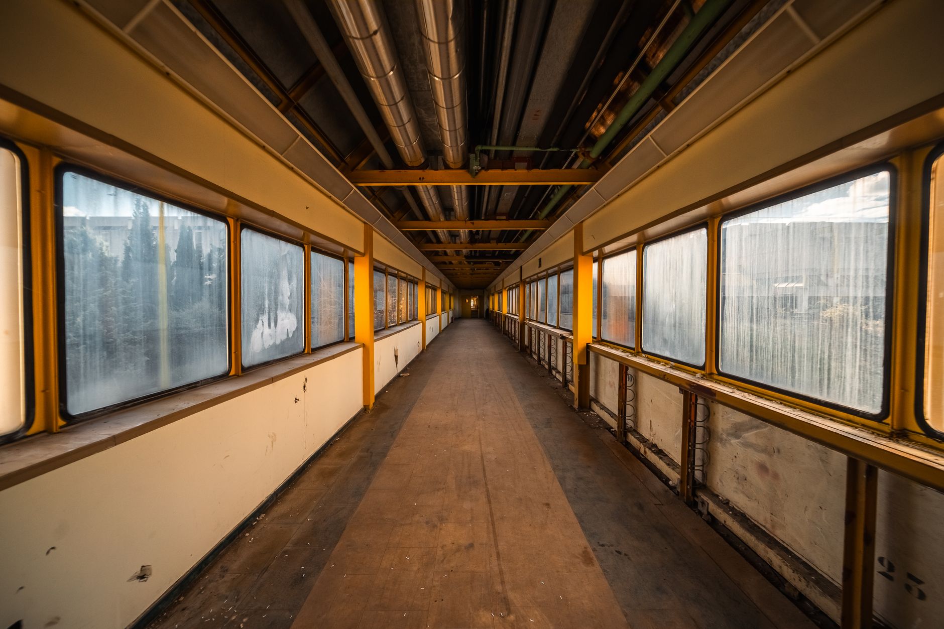 Industrial hallway with sealed concrete flooring where locker aisles are measured for scrubber width.