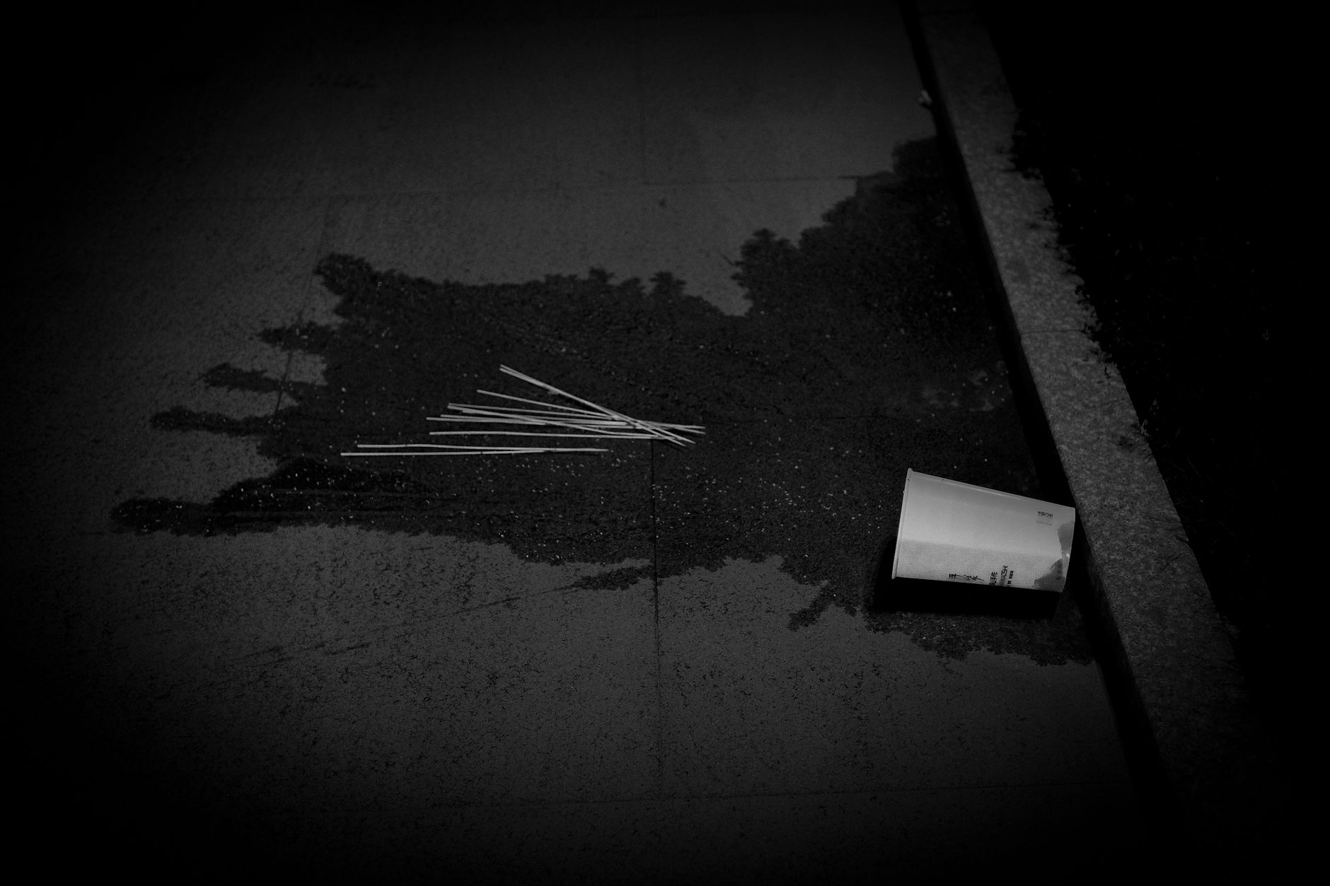 A spilled drink on a hard floor illustrates the sticky hazards that staff should remove before an automated cleaning run.