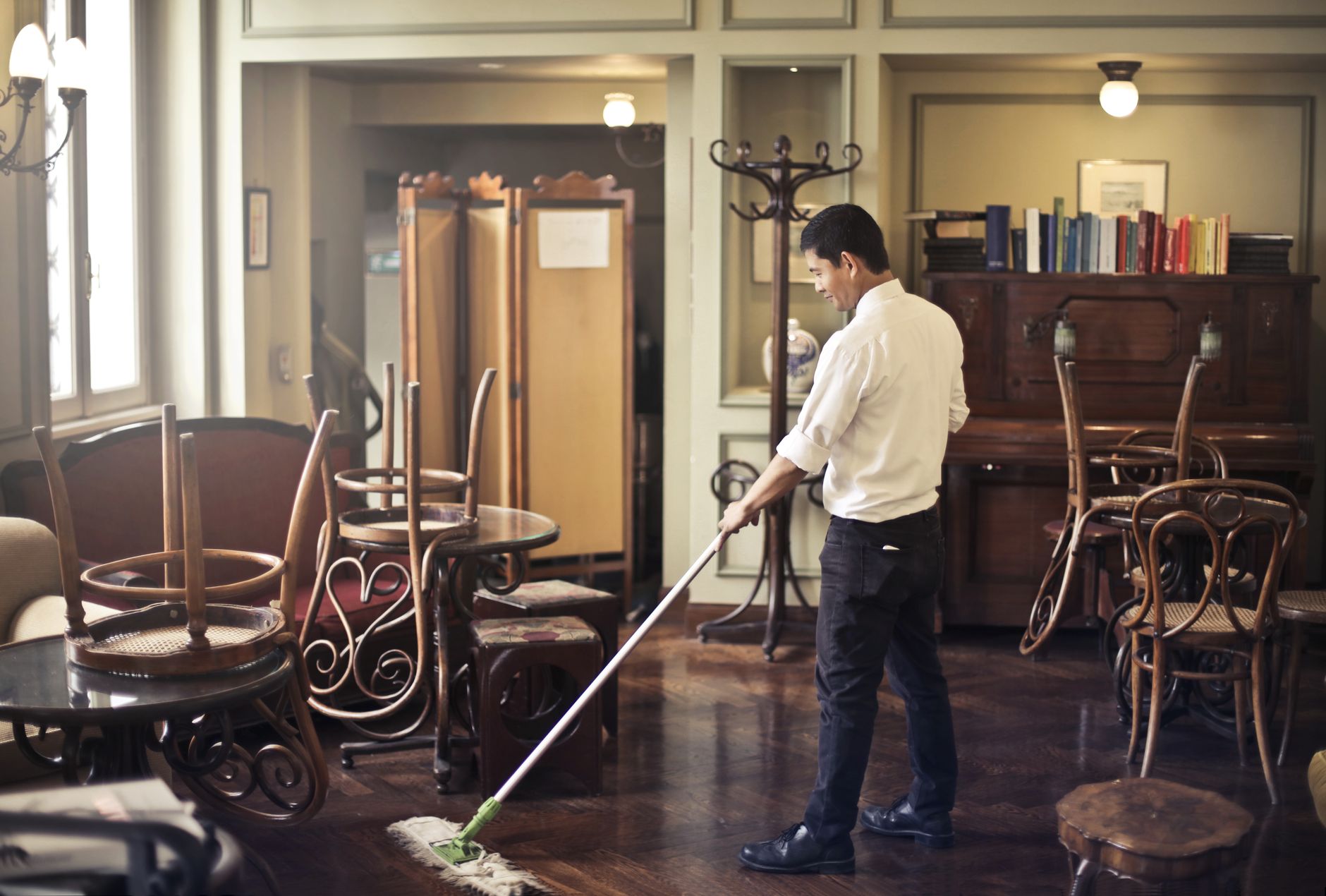 A worker cleaning a terminal floor after hours, matching the article's point that repeatable overnight floor care is usually the first strong airport automation use case.