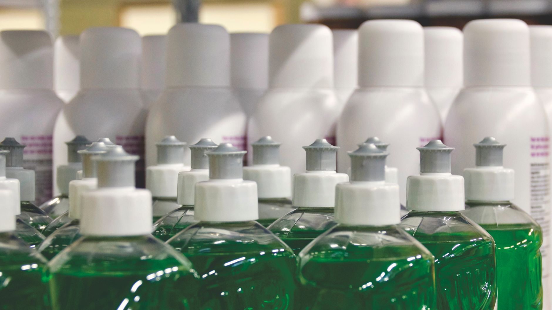 Shelved cleaning consumables that feed the numerator when costing each completed scrub task.