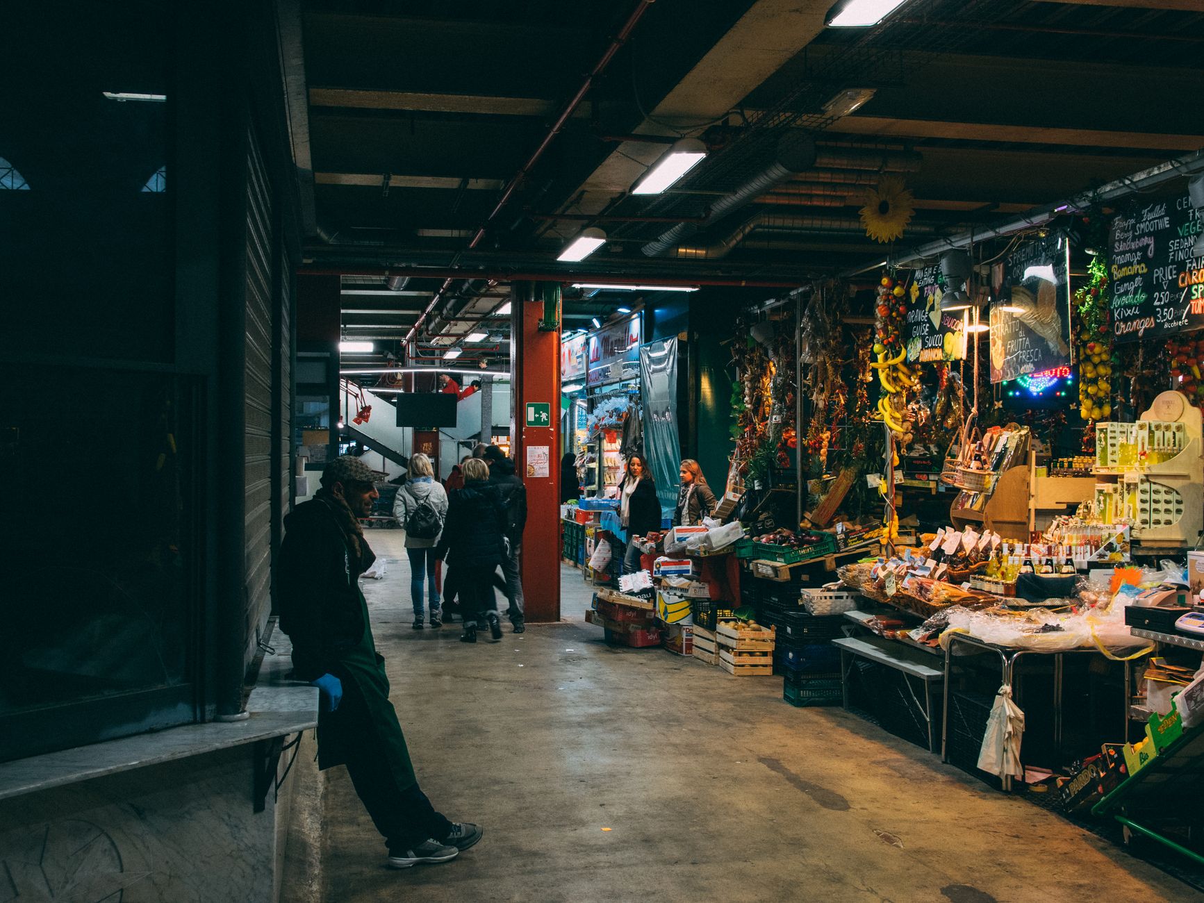 A broad hard-surface shop floor with open aisles and dust tracks, showing the kind of predictable overnight cleaning area that suits first-step floor automation.