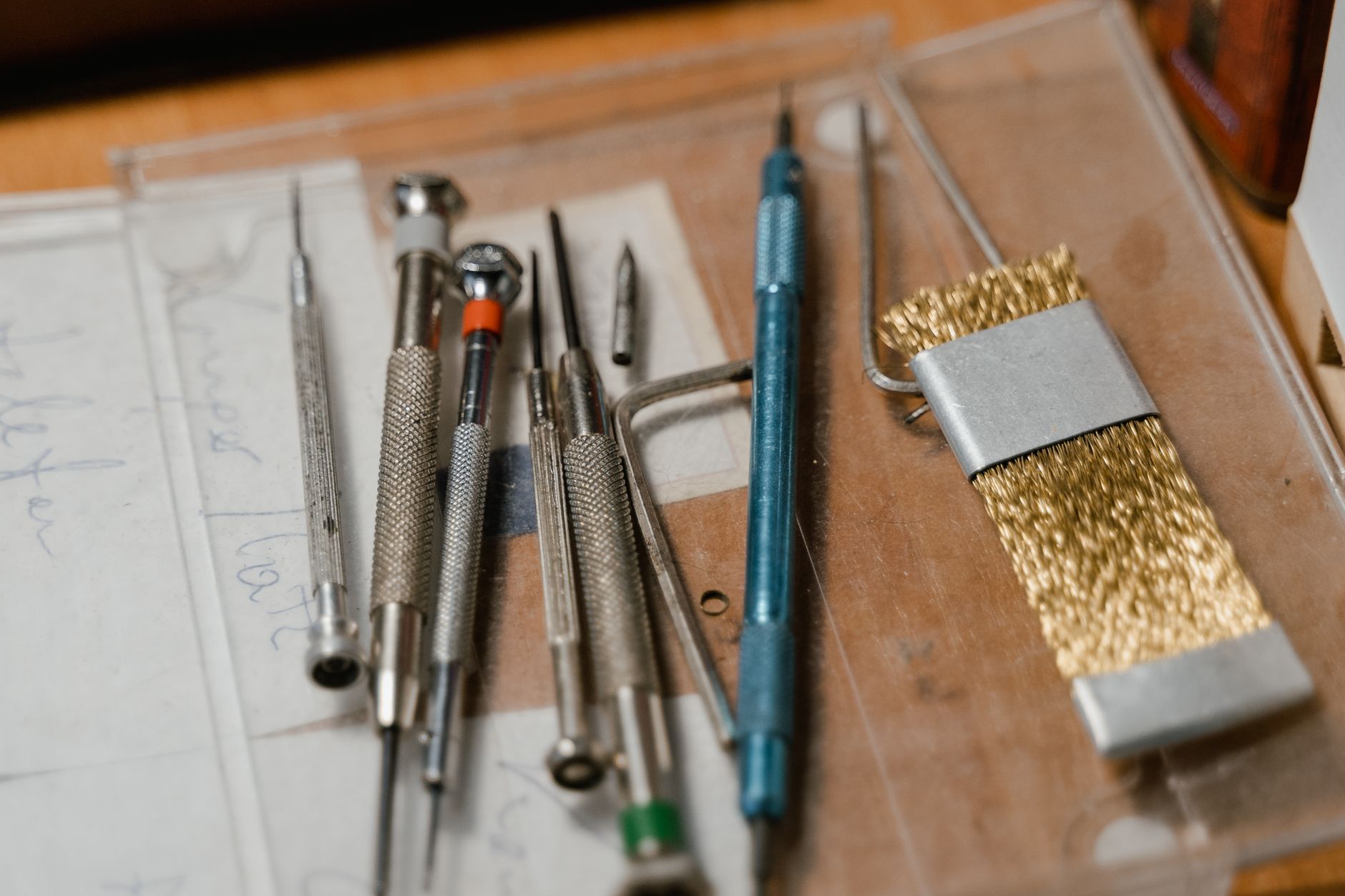 Technician using a powered screwdriver at a bench, matching the repetitive fastener work that is often automated first.