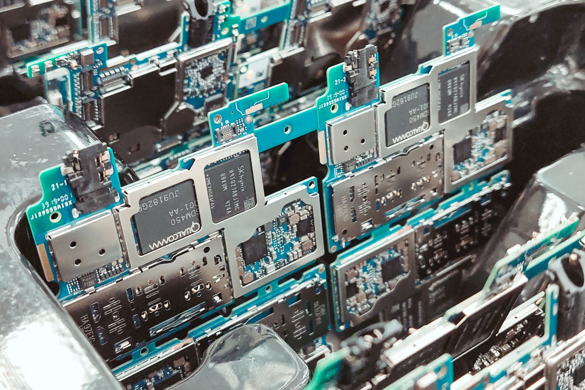 Close view of a circuit board held in a repeatable fixture, illustrating why part presentation and tooling matter more than the arm alone.