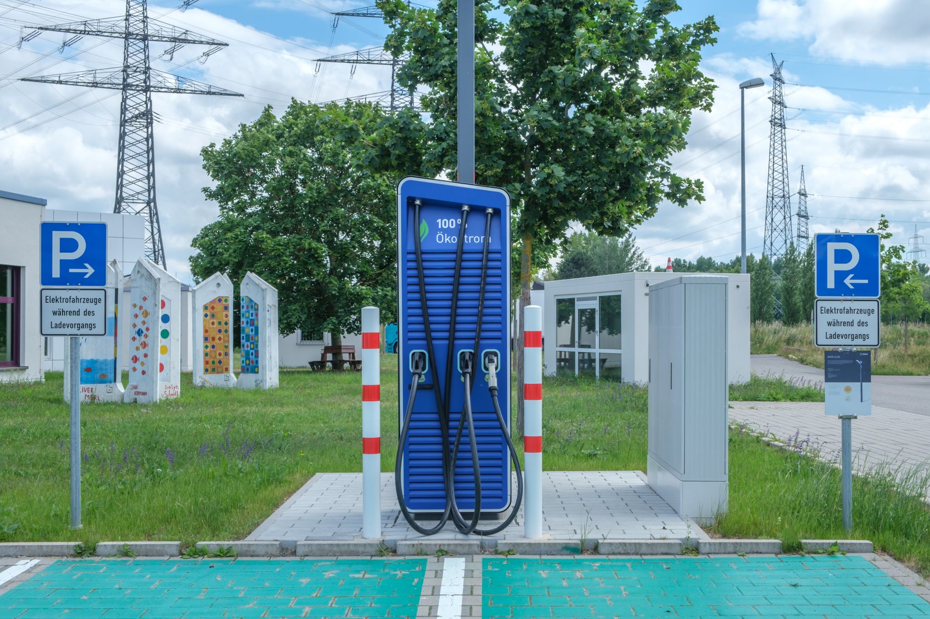 Organized charging station with cables and marked floor boundaries, showing the kind of service area that should stay separate from cleaning docks.