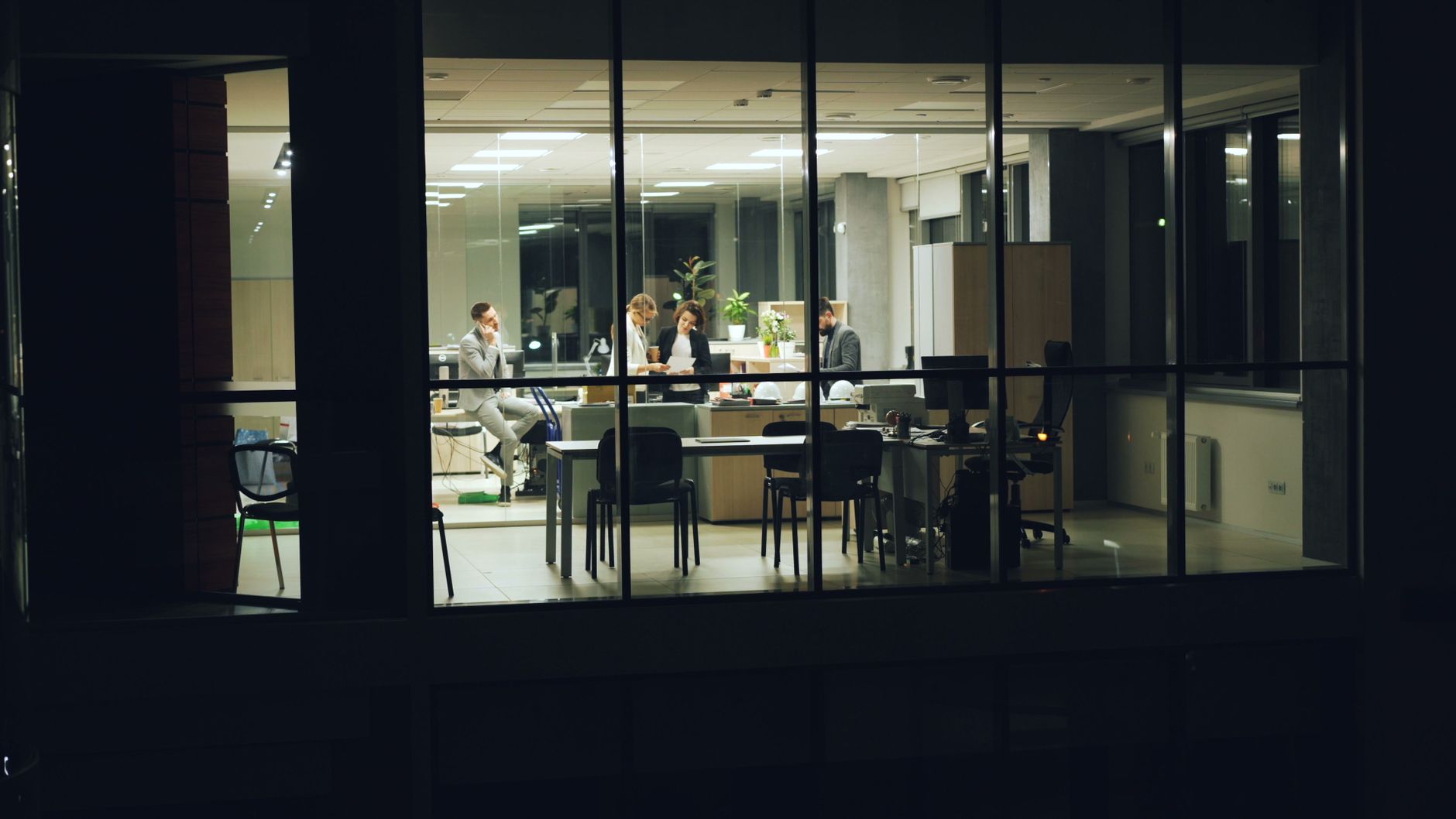 A supervisor working a late shift at a desk fits the article’s focus on alerts that help people act quickly instead of ignoring noisy notifications.