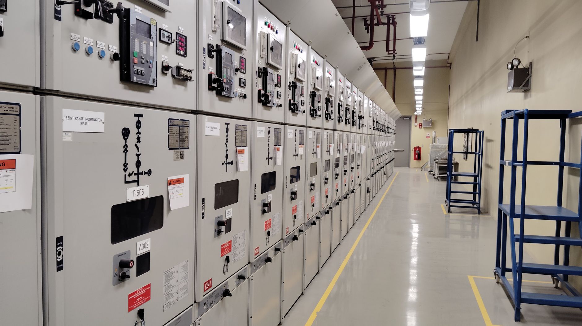 Clear working space in front of electrical panels inside a facility, echoing the charger relocation and power-access planning described in the article.
