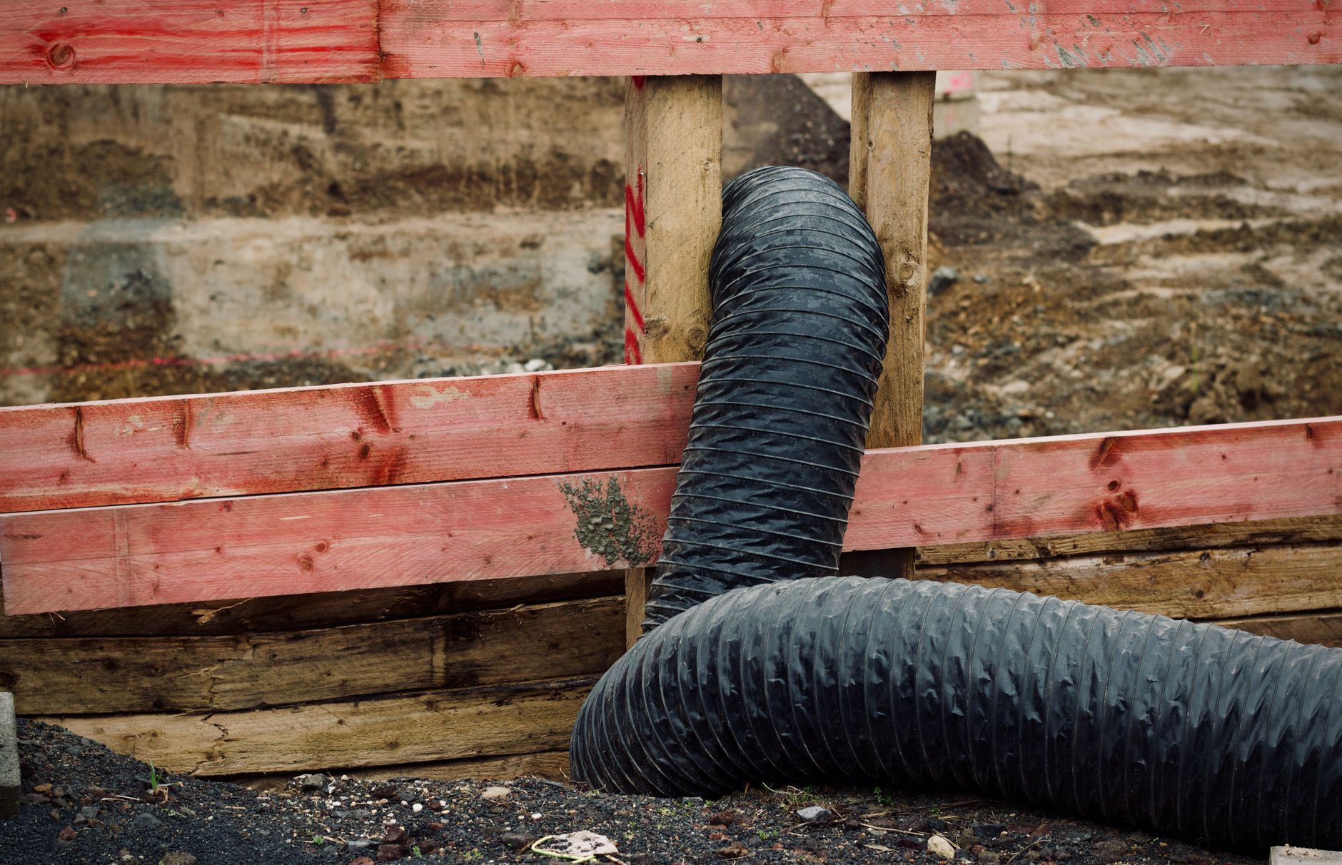 Plastic dust barriers and warning cones dividing a commercial corridor during renovation, matching the phased remodel conditions that can disrupt fleet routes.